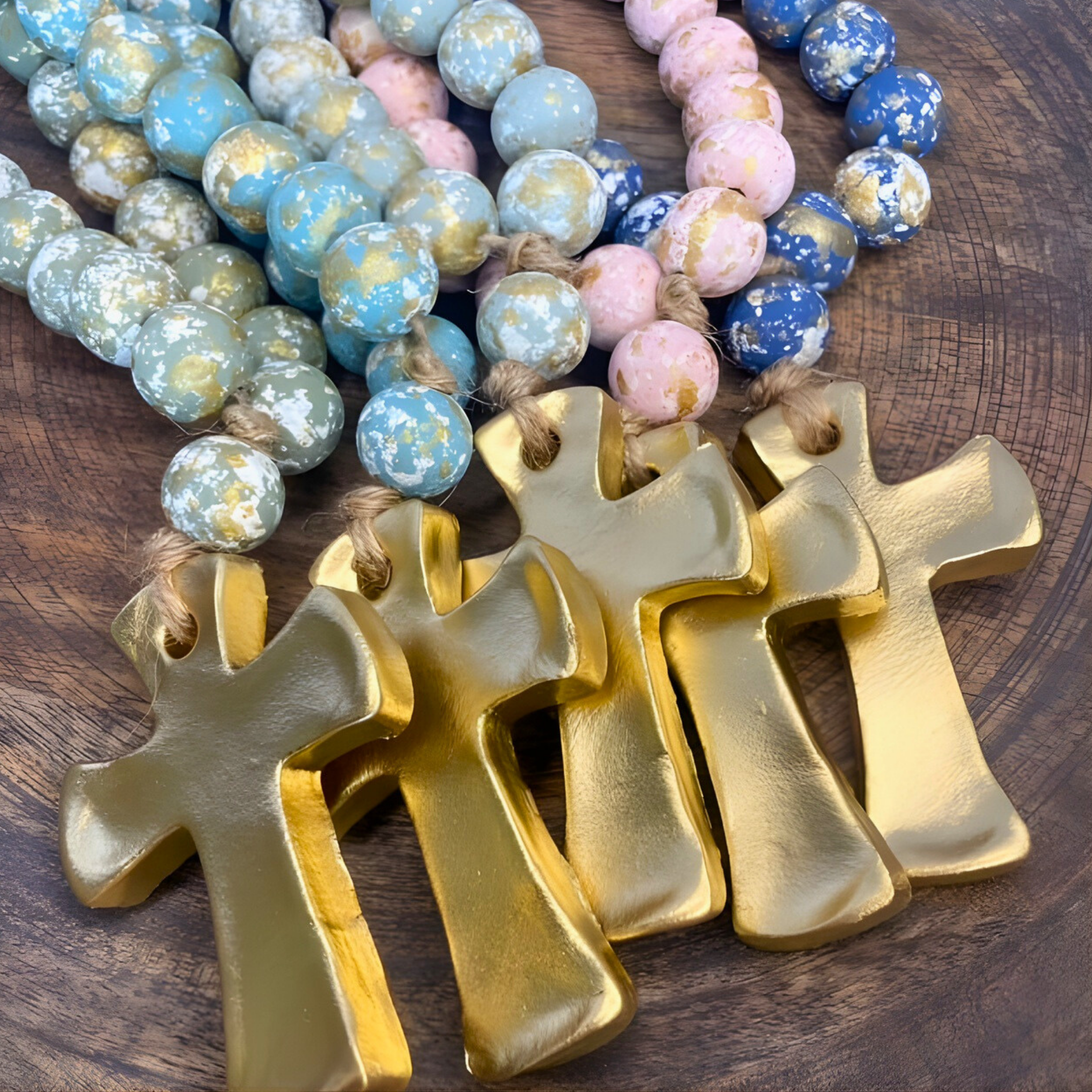 Gold crosses with colorful beaded necklaces on a wooden surface