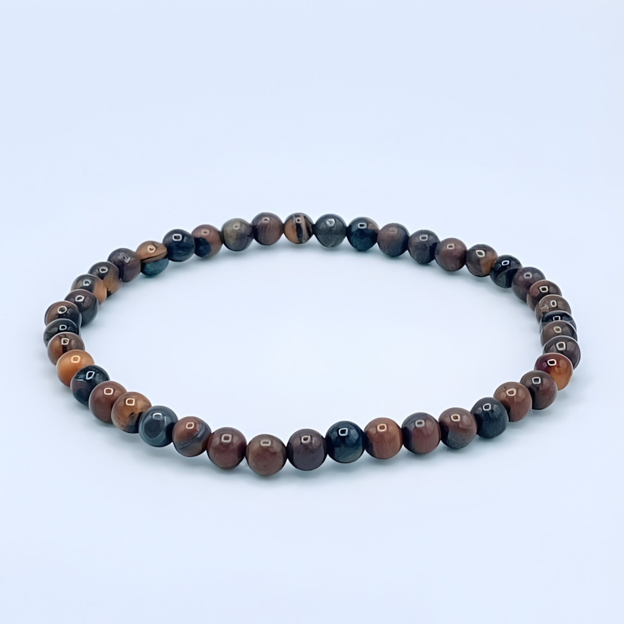 Beaded bracelet with multicolored beads on a light blue background