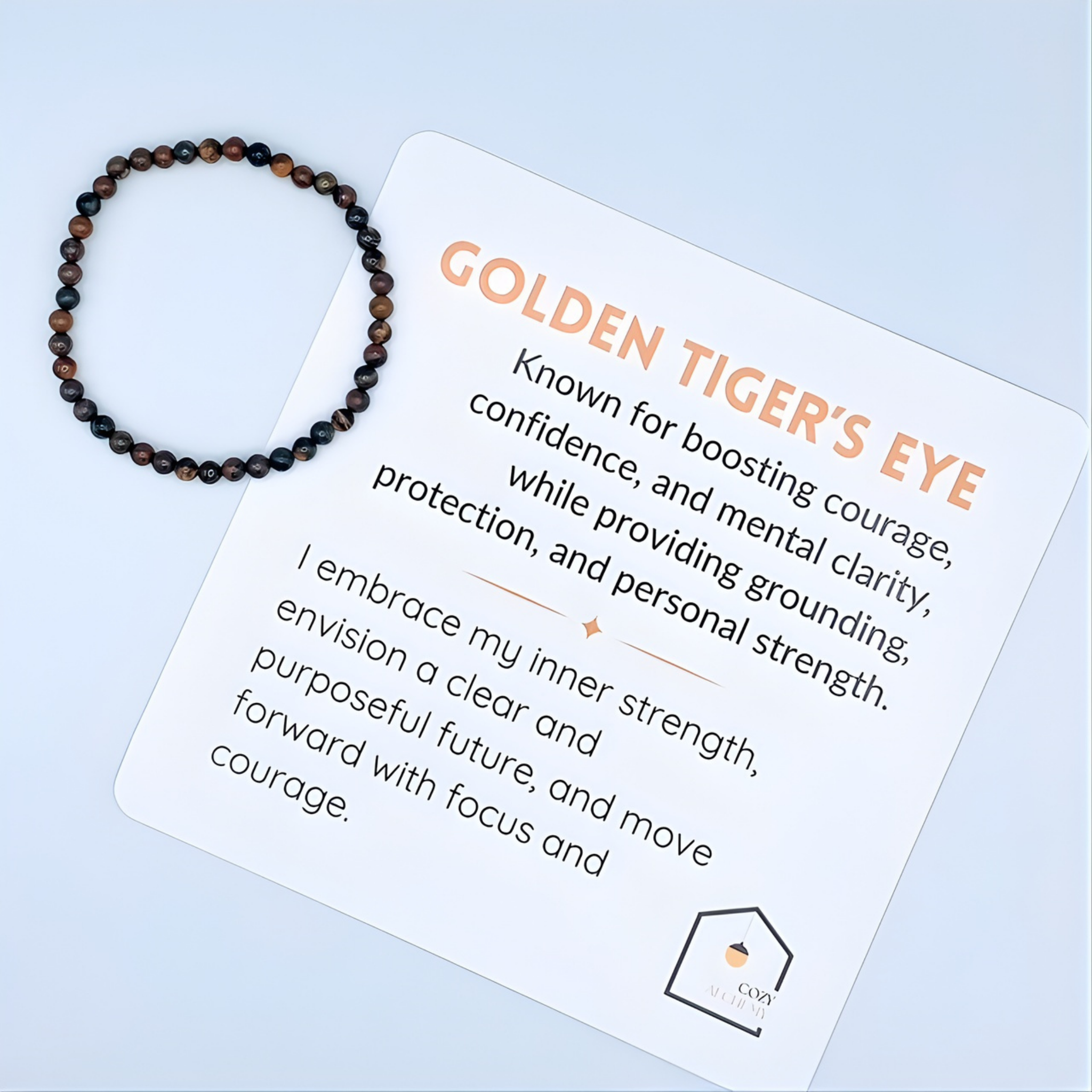 Beaded bracelet on a card with 'Golden Tiger's Eye' information on a light blue background