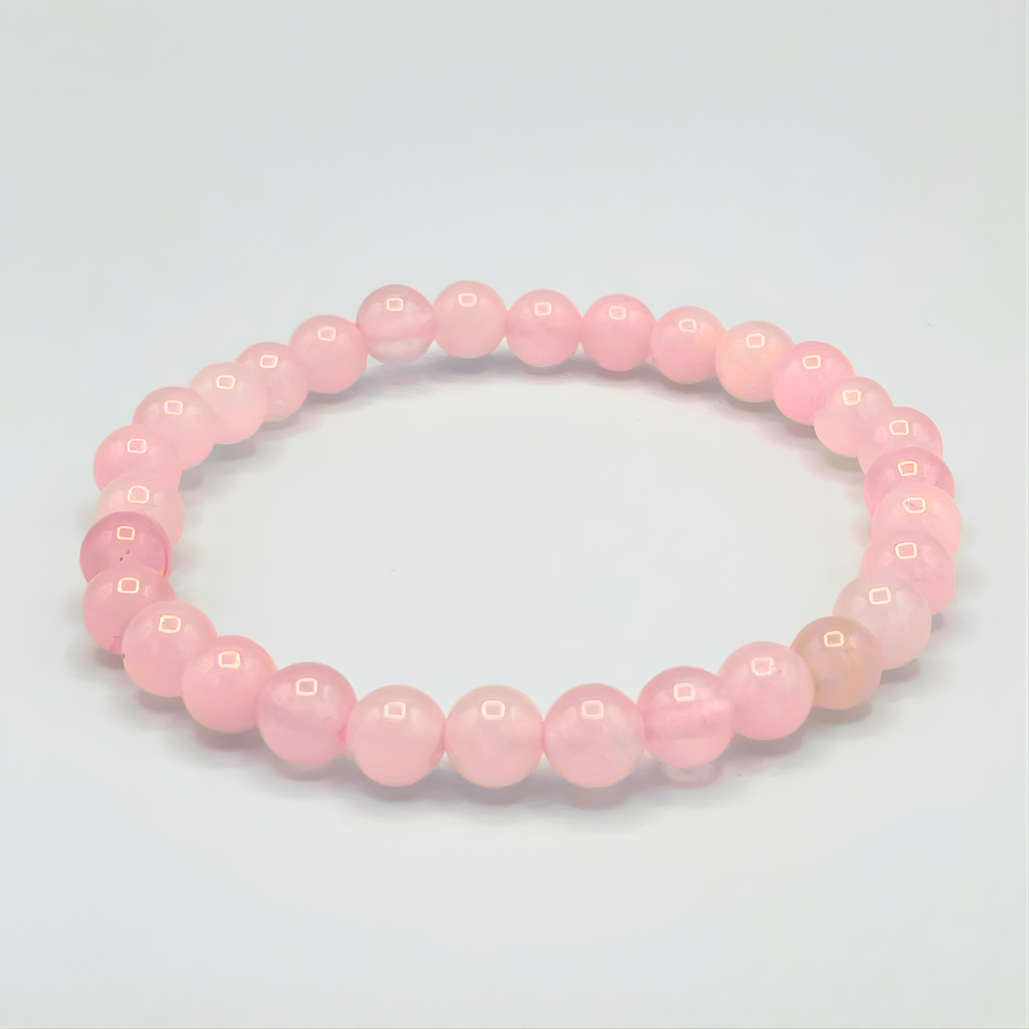 Pink beaded bracelet on a light gray background