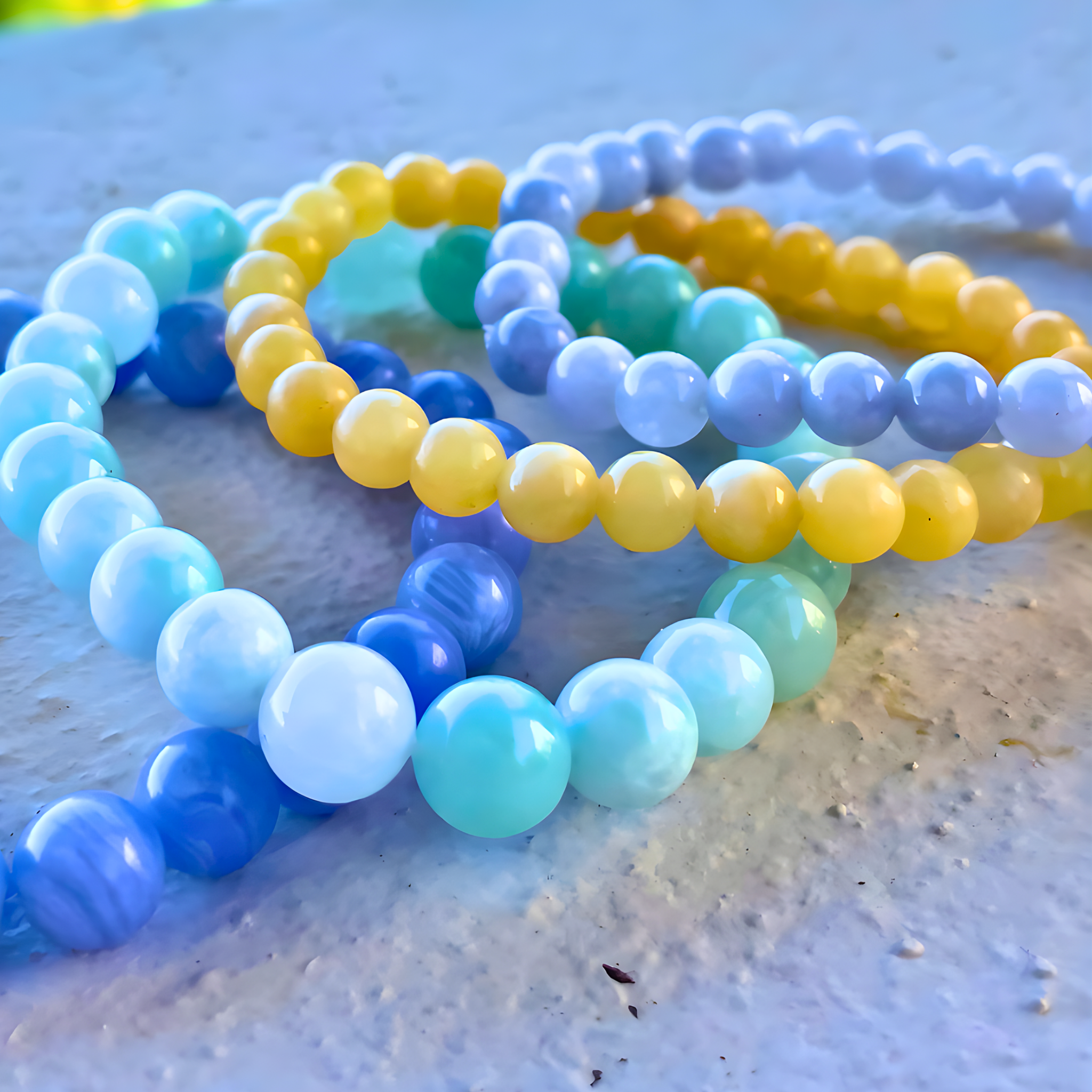 Set of colorful beaded bracelets on a textured surface