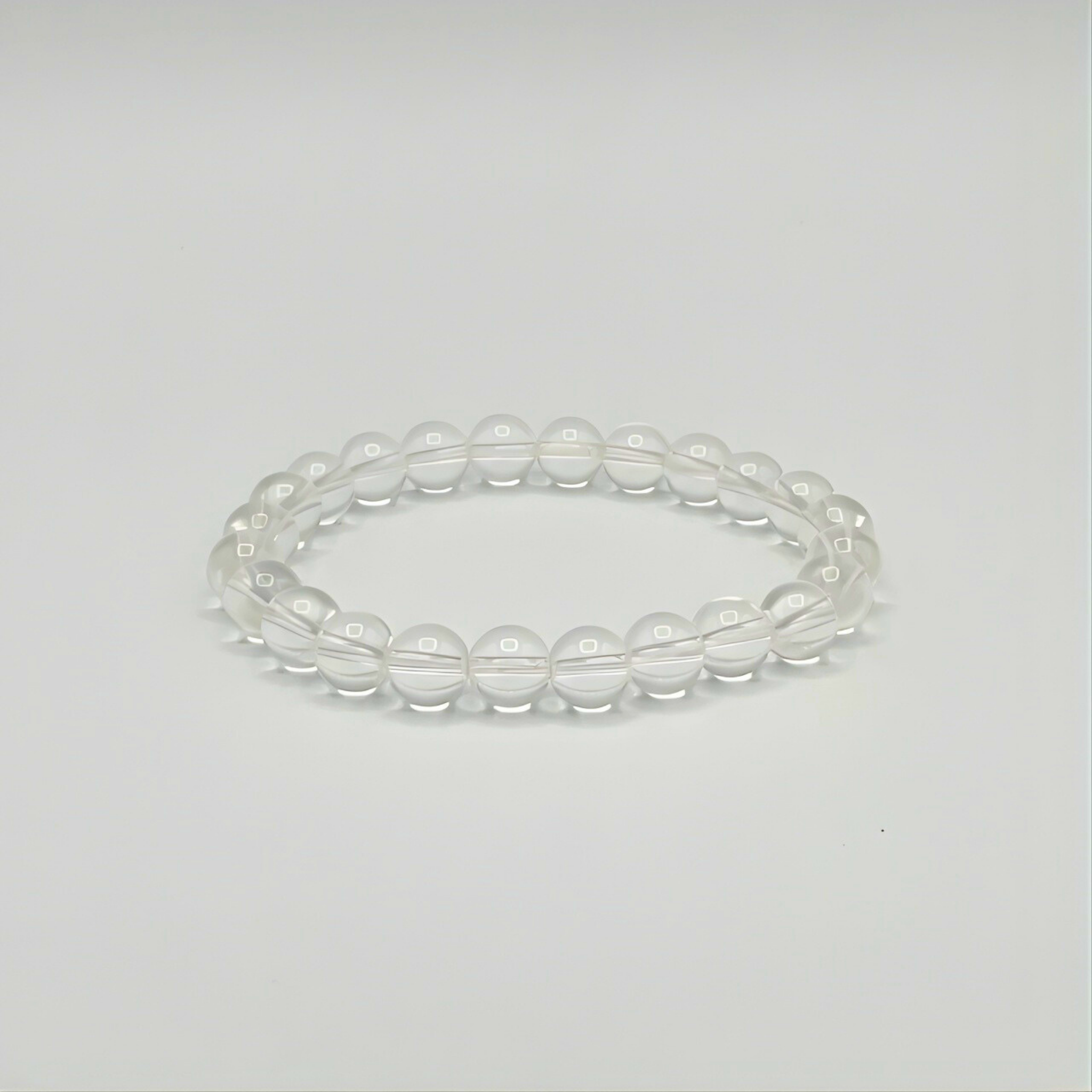Clear beaded bracelet on a light gray background