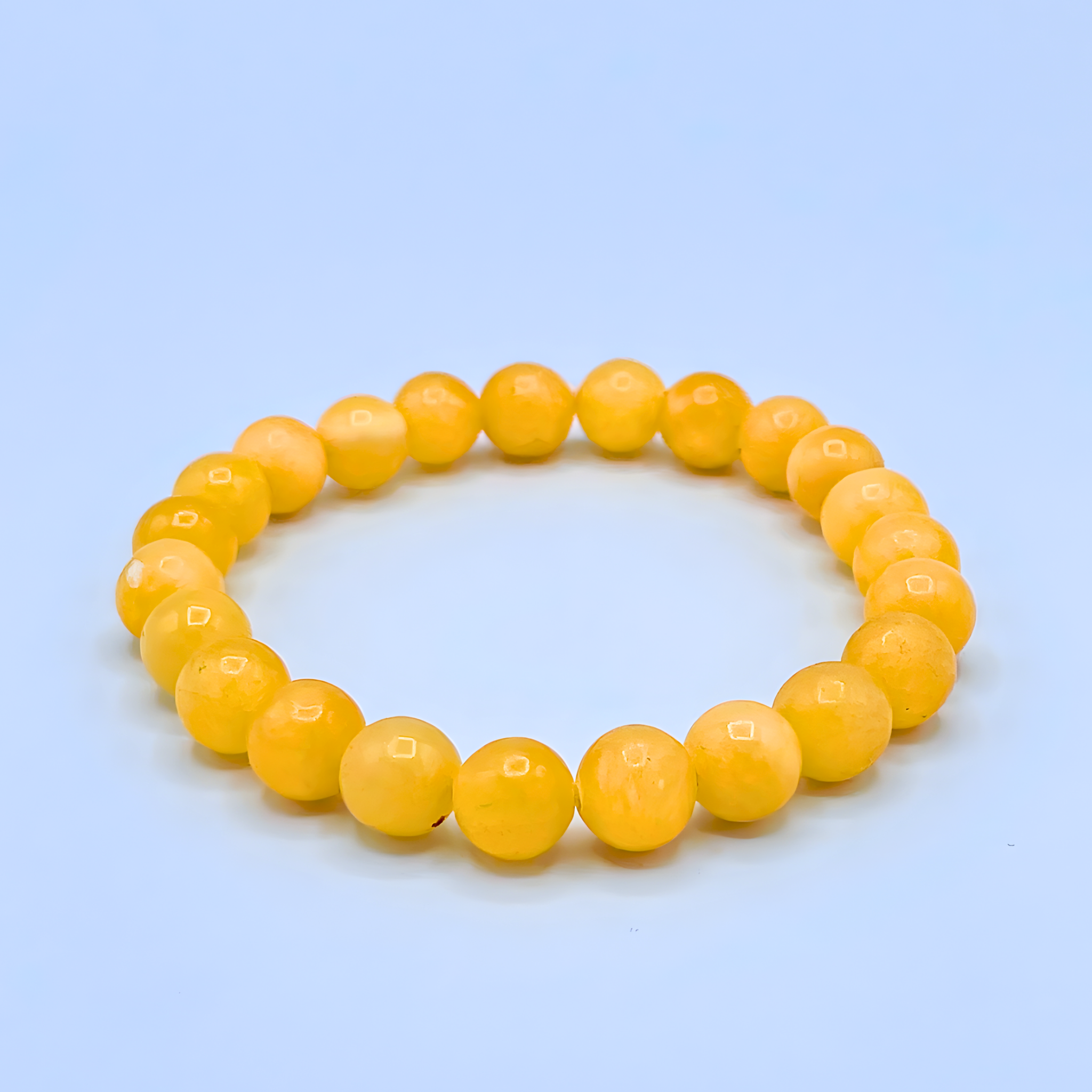 Yellow beaded bracelet on a light blue background