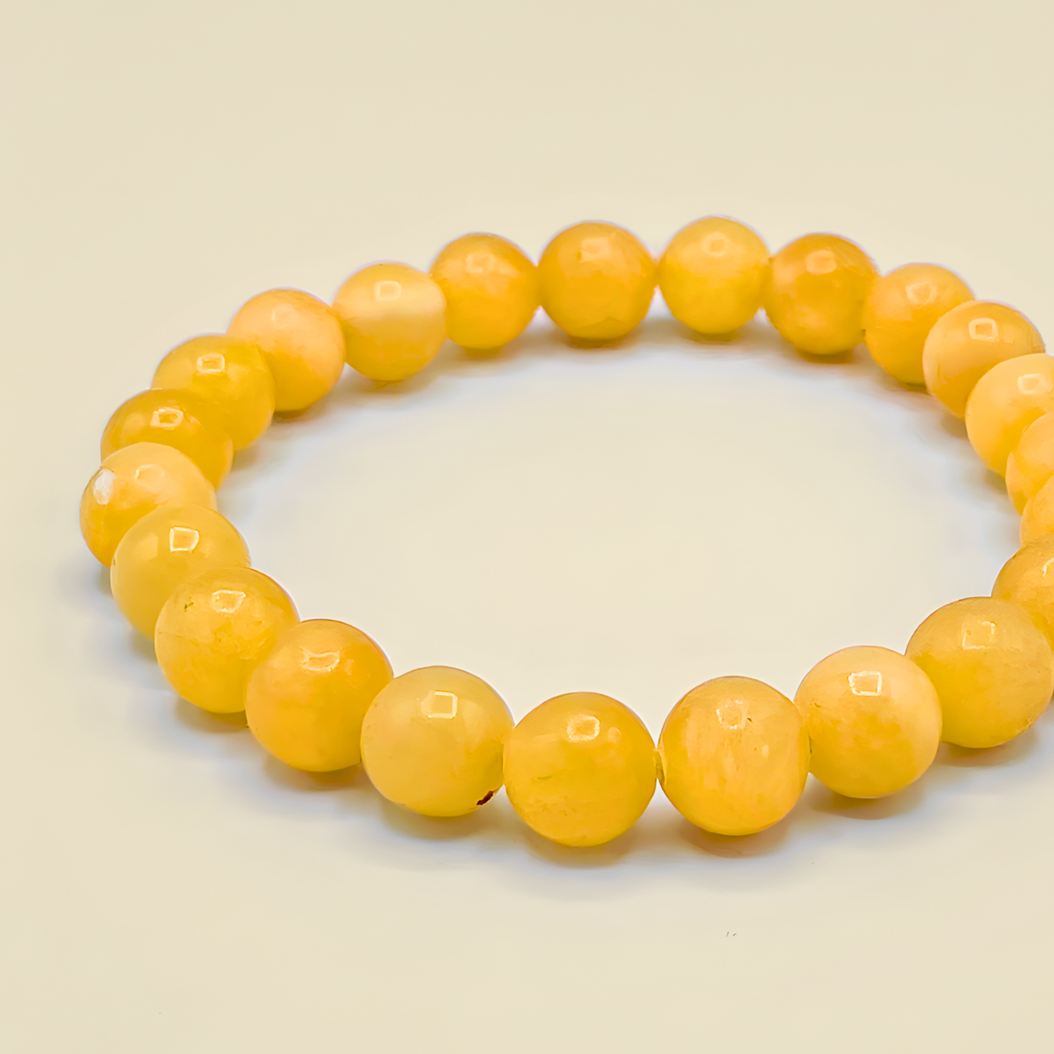 Yellow beaded bracelet on a beige background