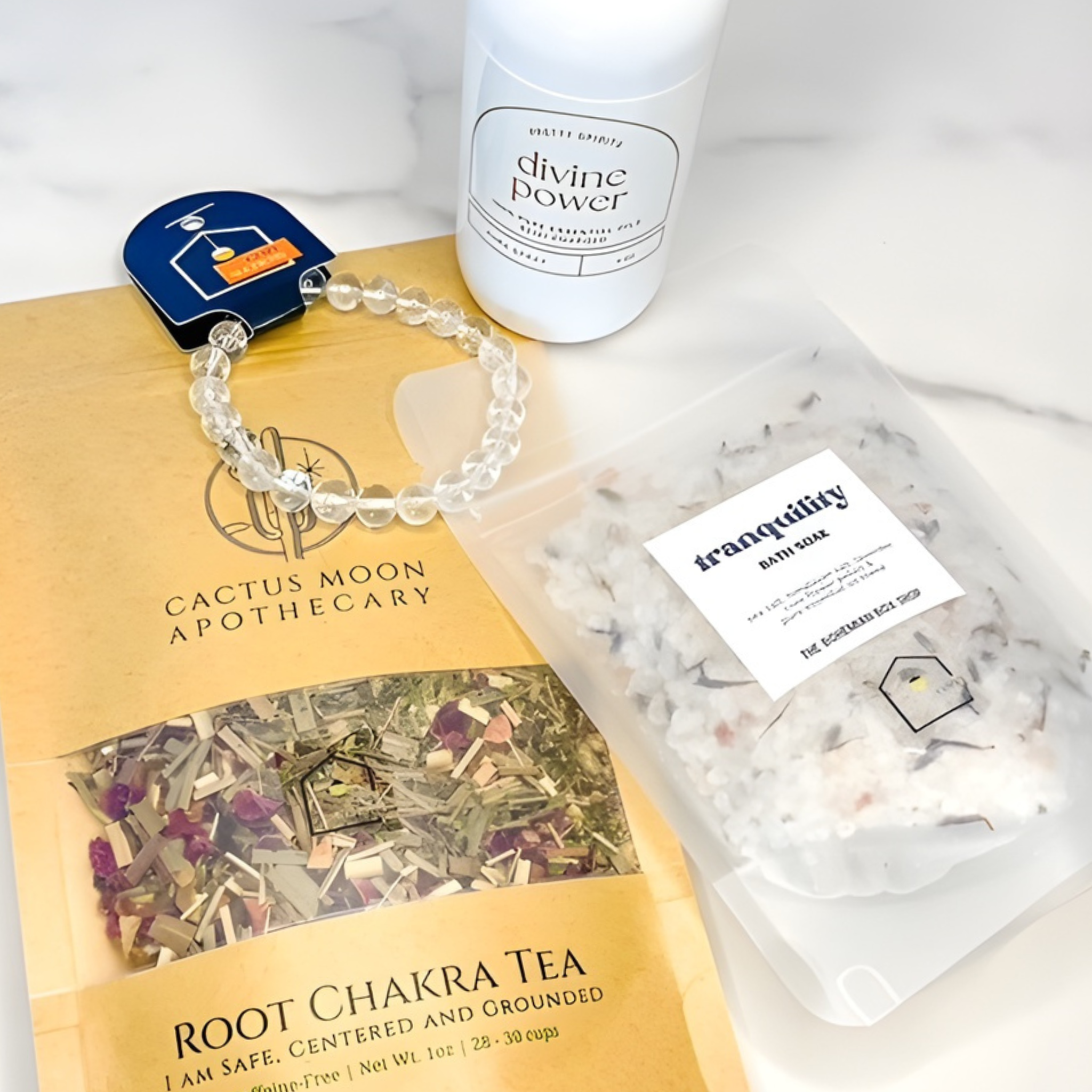 Cactus Moon Apothecary Root Chakra Tea, bracelet, and bath bomb on a white background