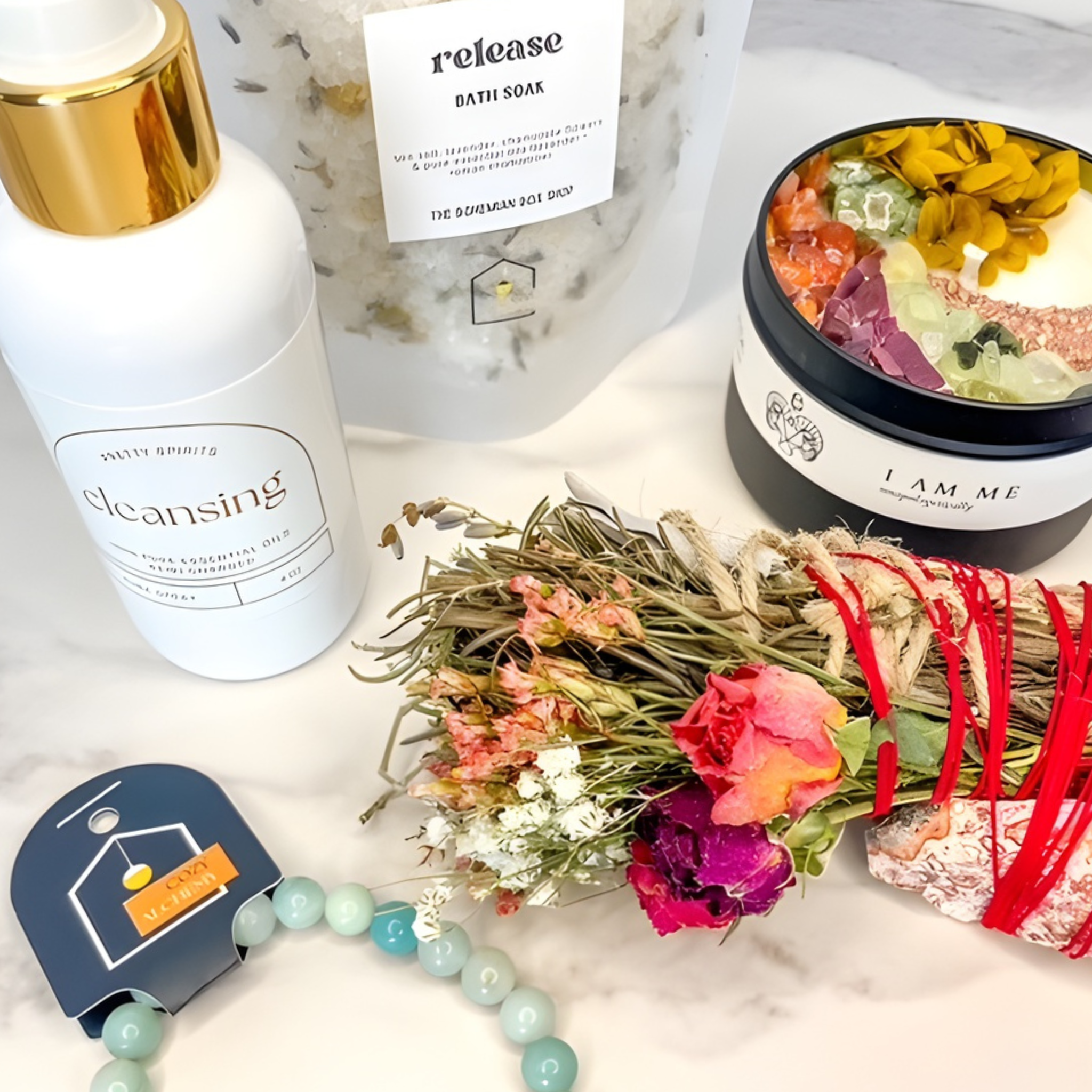 Assorted beauty products including a bottle labeled 'cleansing', a jar, and a bouquet of flowers on a marble surface.