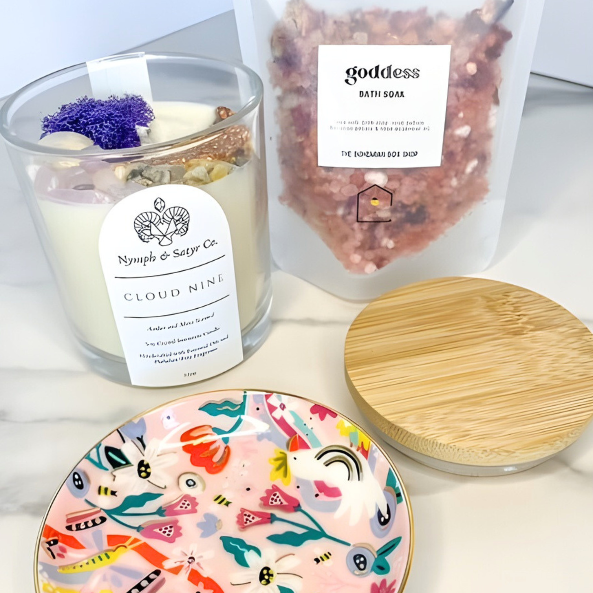 Candle labeled 'Cloud Nine' with a decorative plate and wooden lid on a light surface.