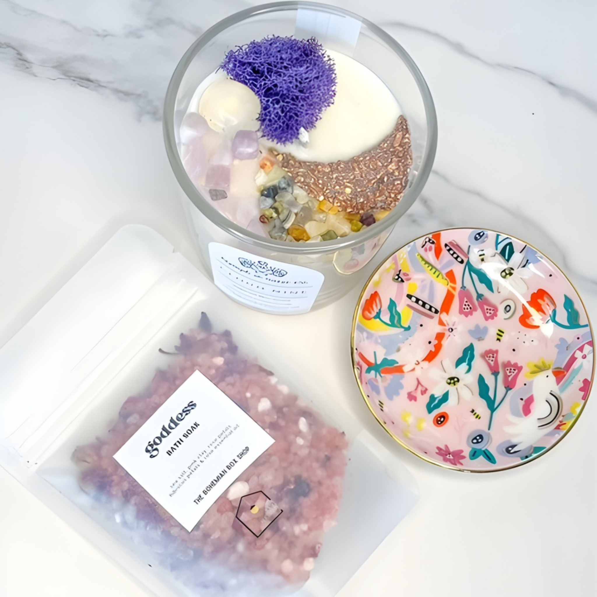 Bath bomb in a clear container with decorative elements on a marble surface