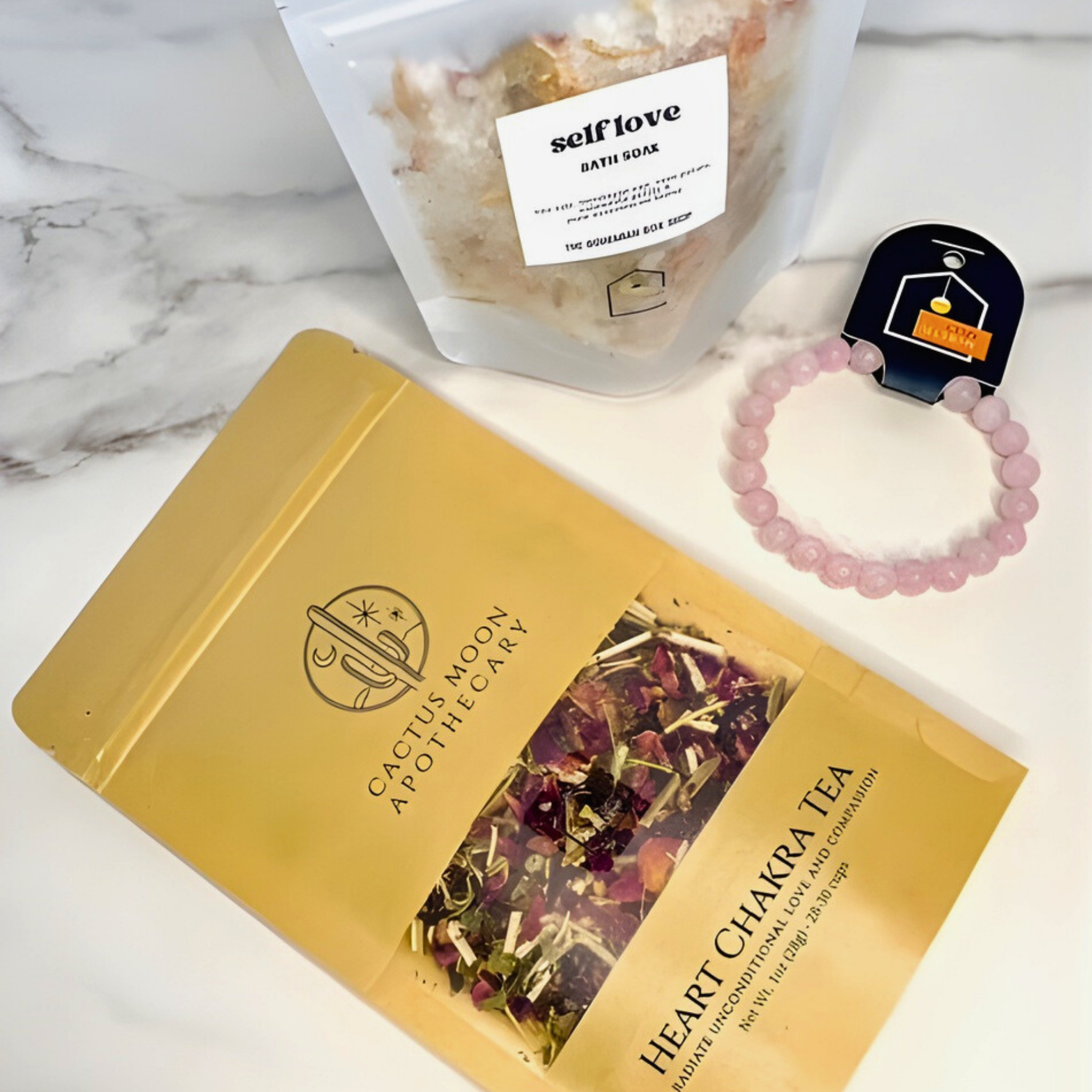 Heart Chakra Tea packaging with Cactus Moon Apothecary branding on a marble surface.