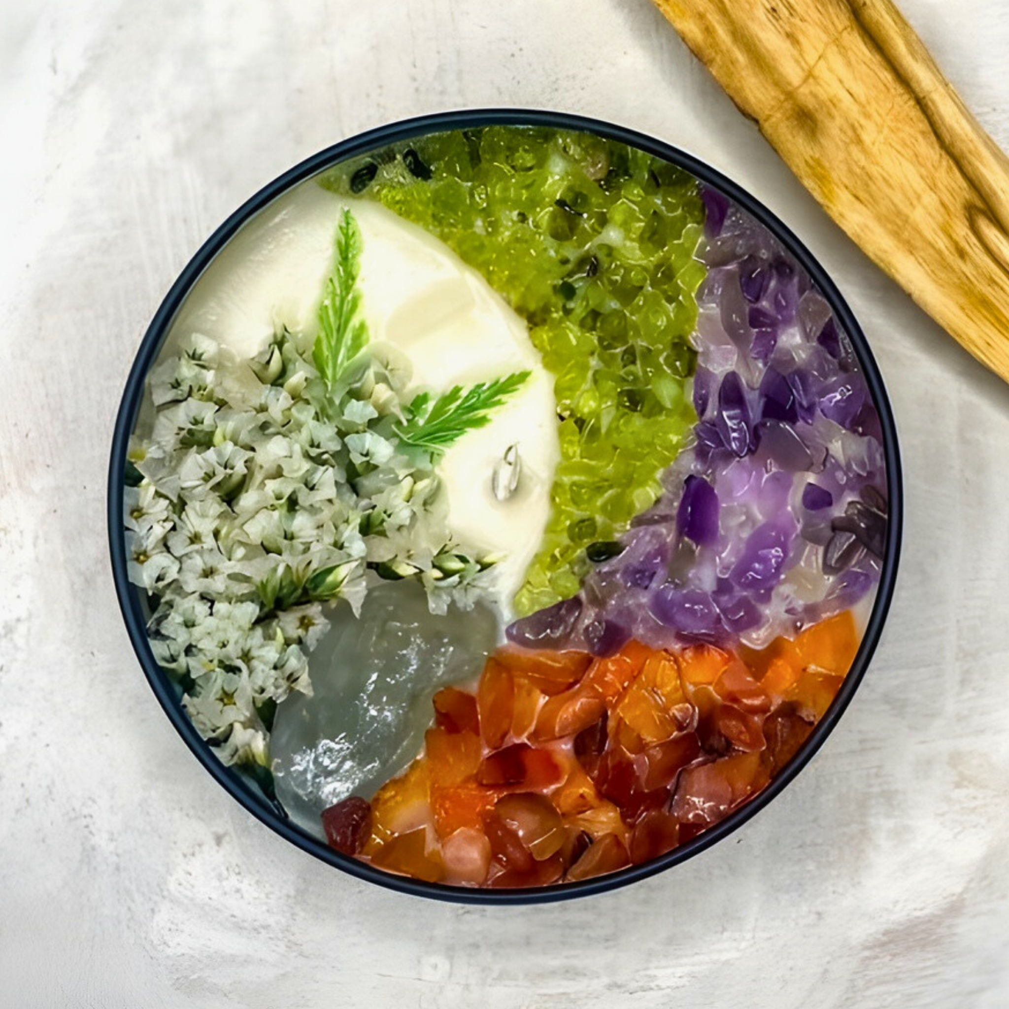 scented candle with flowers and crystals in black jar