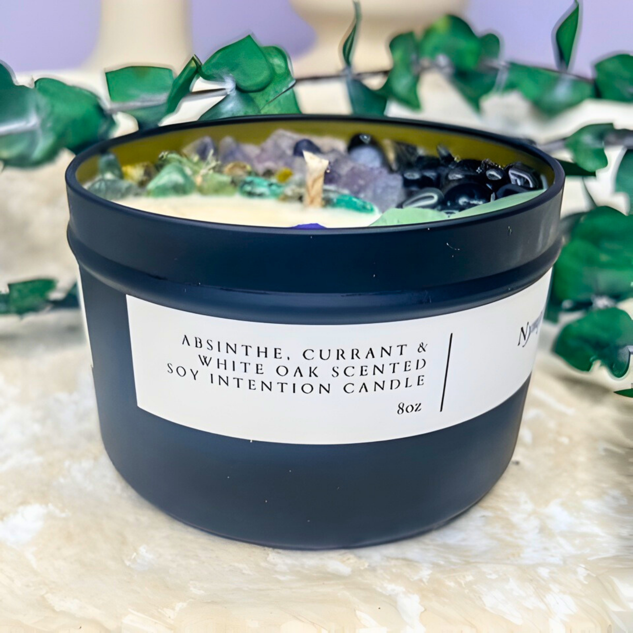 Scented candle with a label on a textured surface