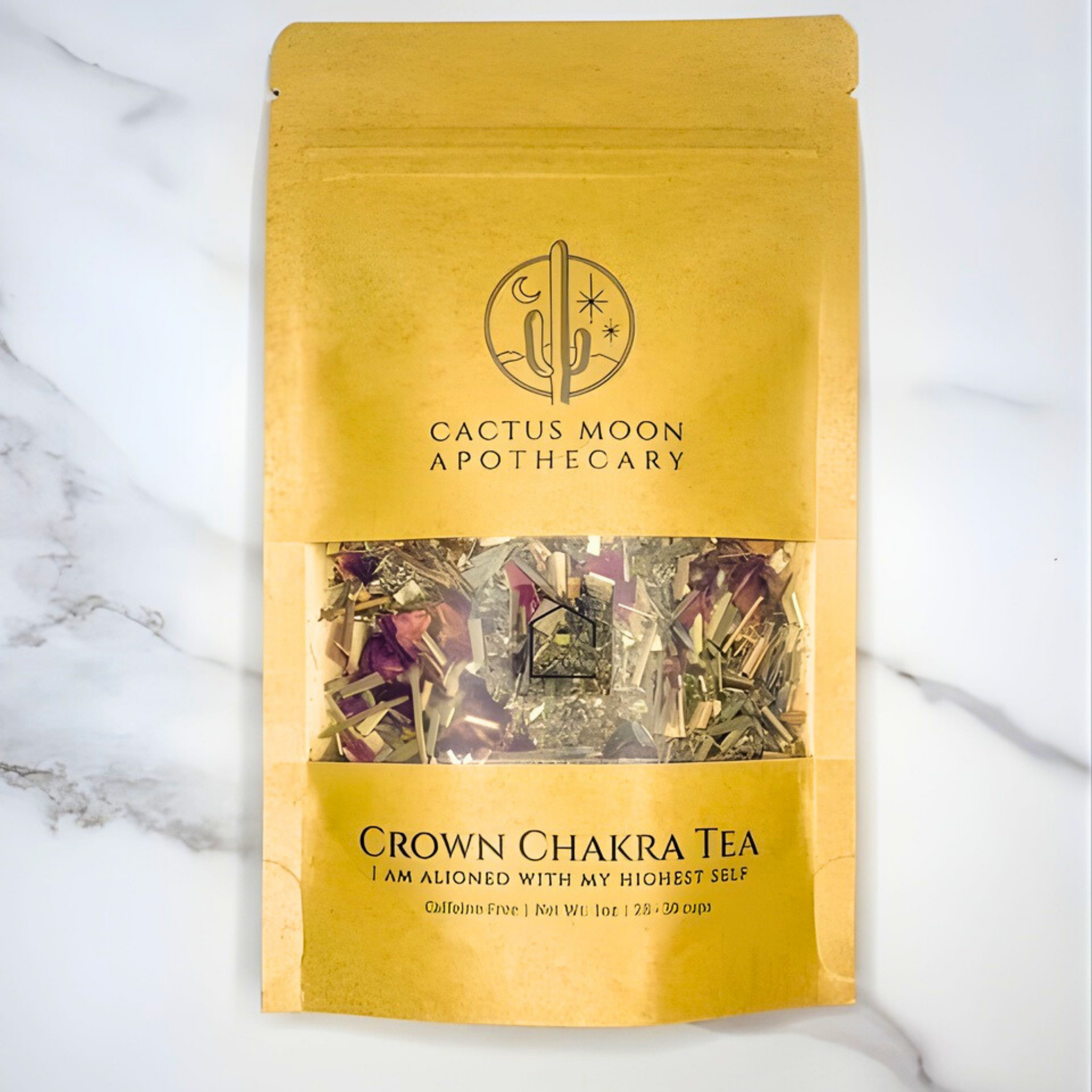 Yellow package of Crown Chakra Tea from Cactus Moon Apothecary on a marble background
