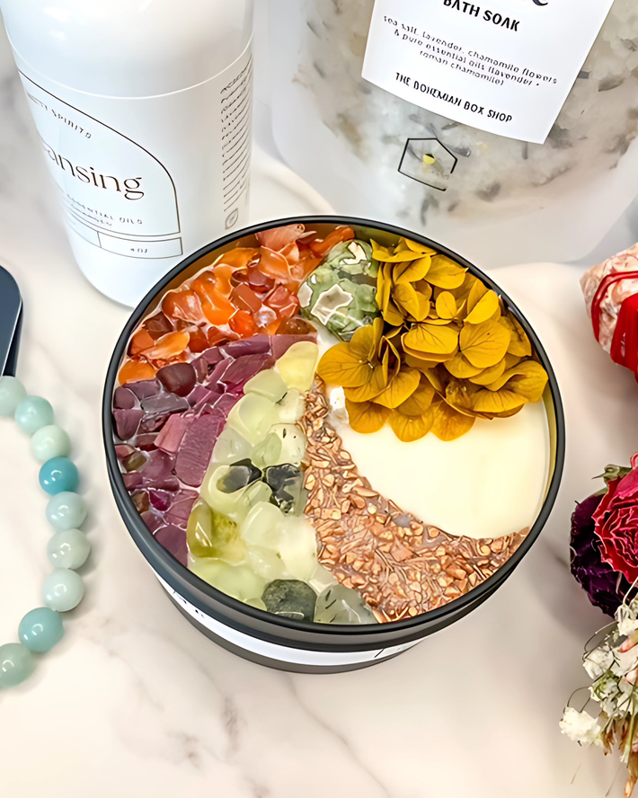 Bowl with colorful bath salts on a marble surface with bath products around