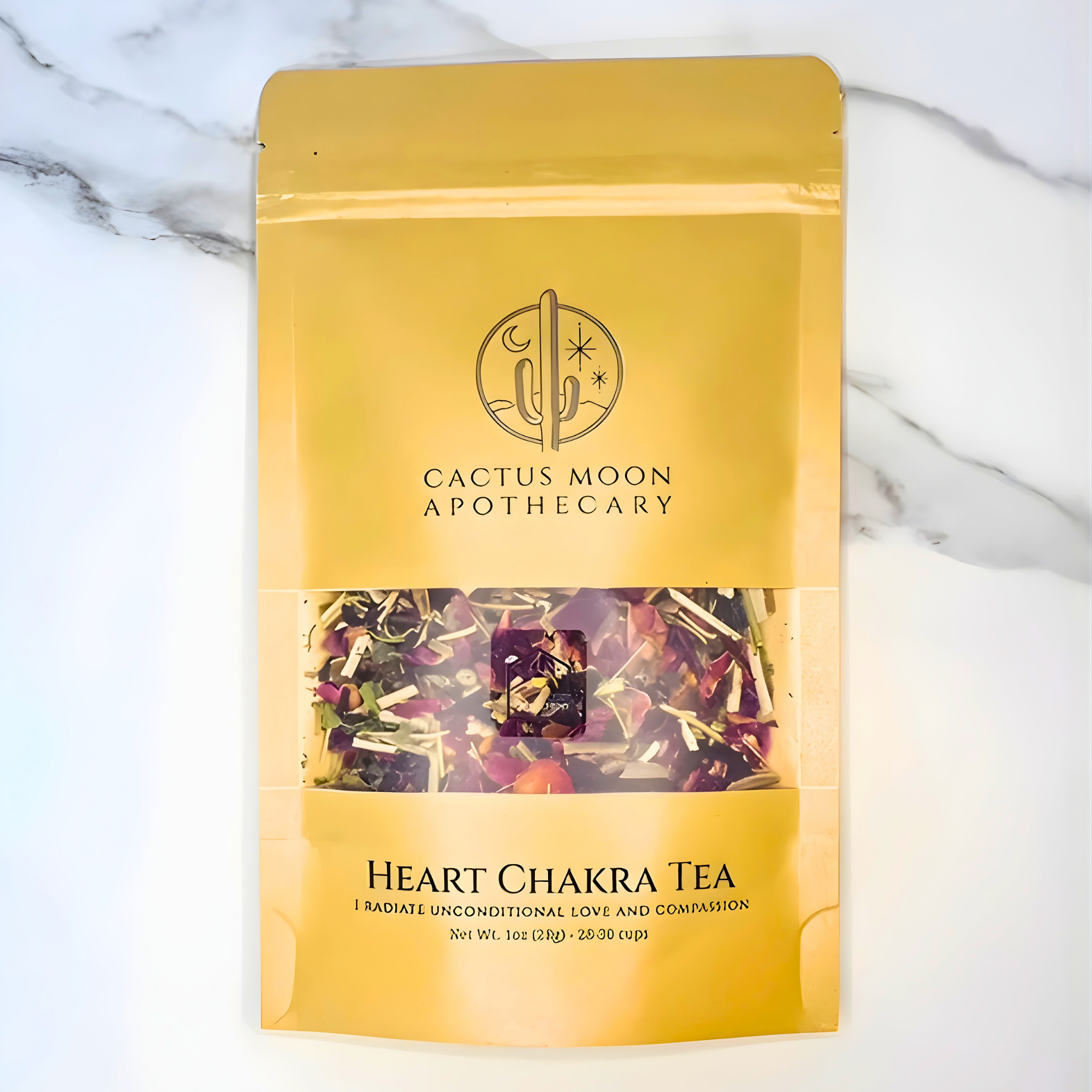Yellow package of Cactus Moon Apothecary Heart Chakra Tea on a marble background