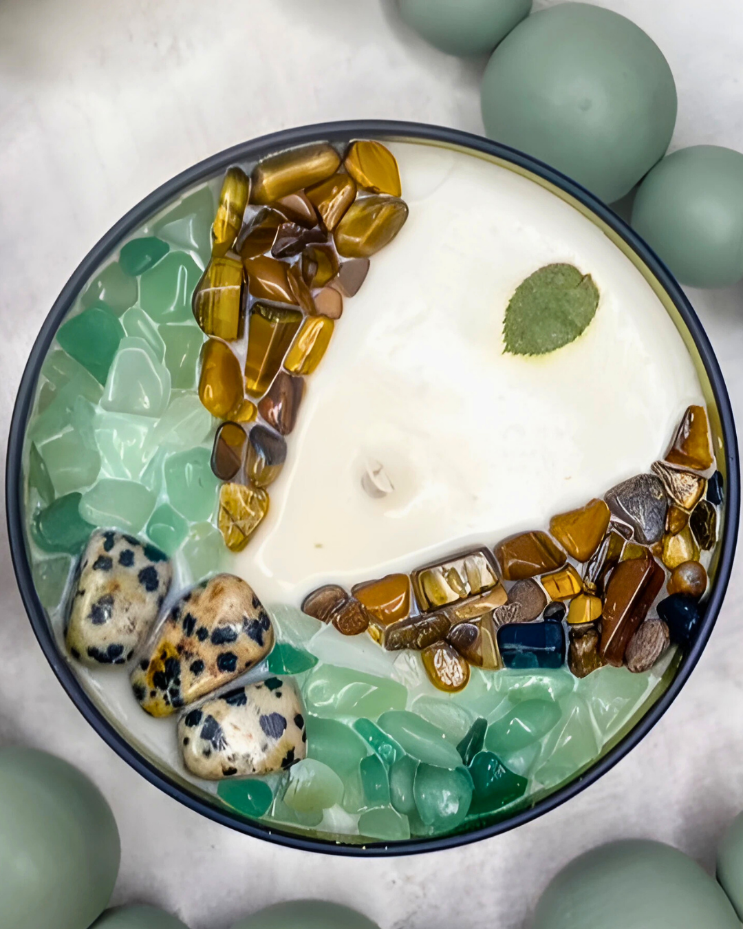 Decorative bowl with stones and a leaf on a light background