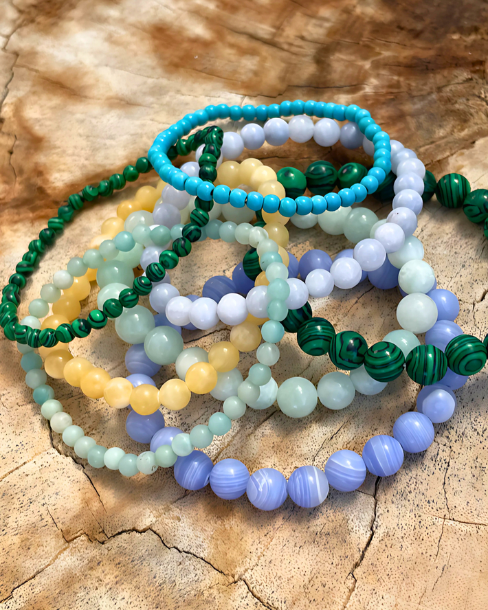 Set of colorful beaded bracelets on a wooden surface