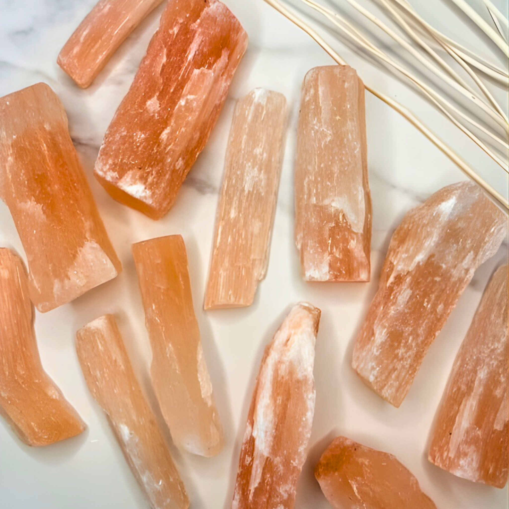 Orange crystal sticks on a light background