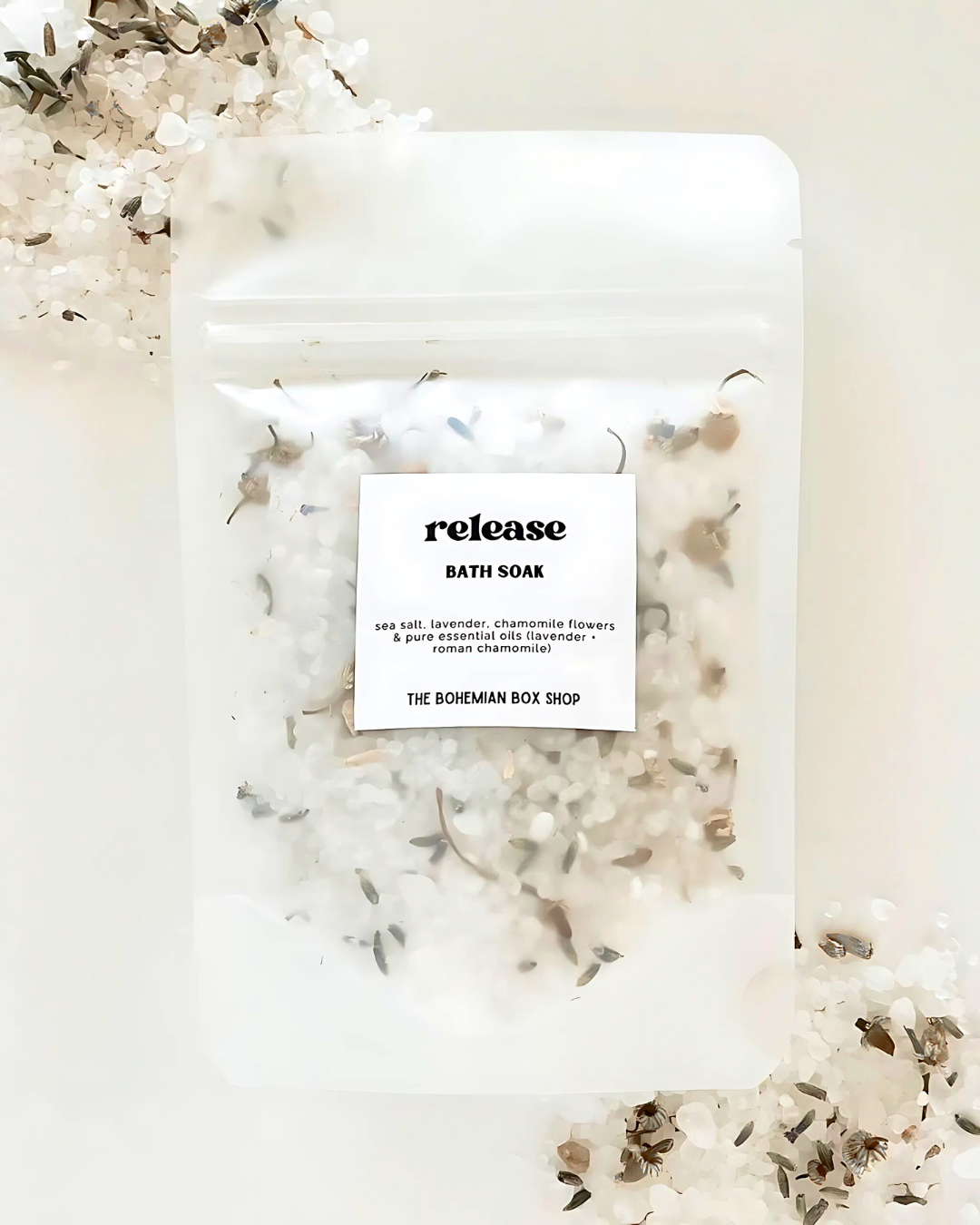 Bath soak package with 'release' text and floral elements on a light background
