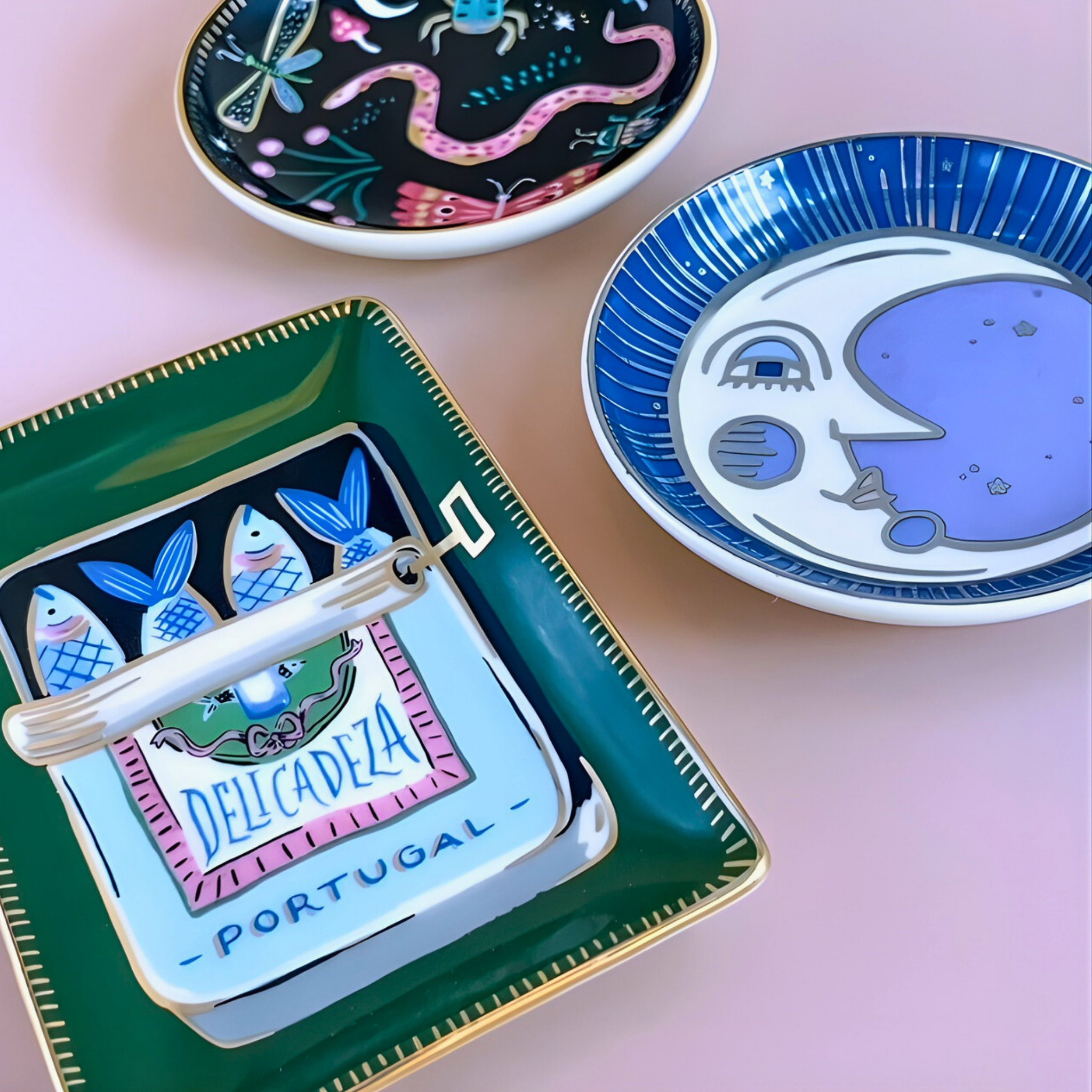 Decorative plates with artistic designs on a pink surface