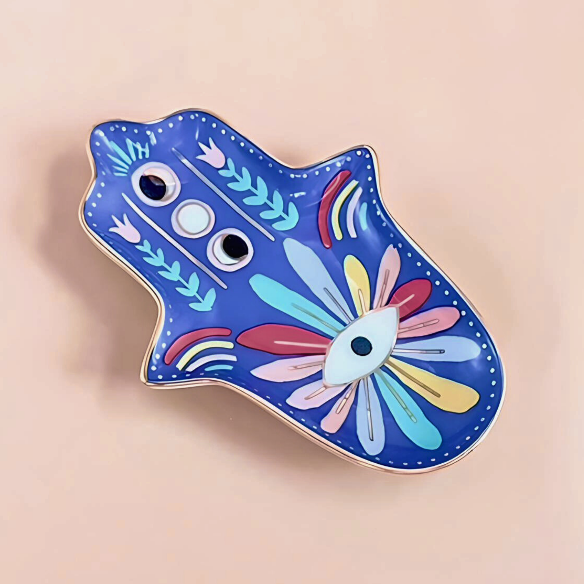 Colorful Hamsa-shaped object with floral design on a beige background