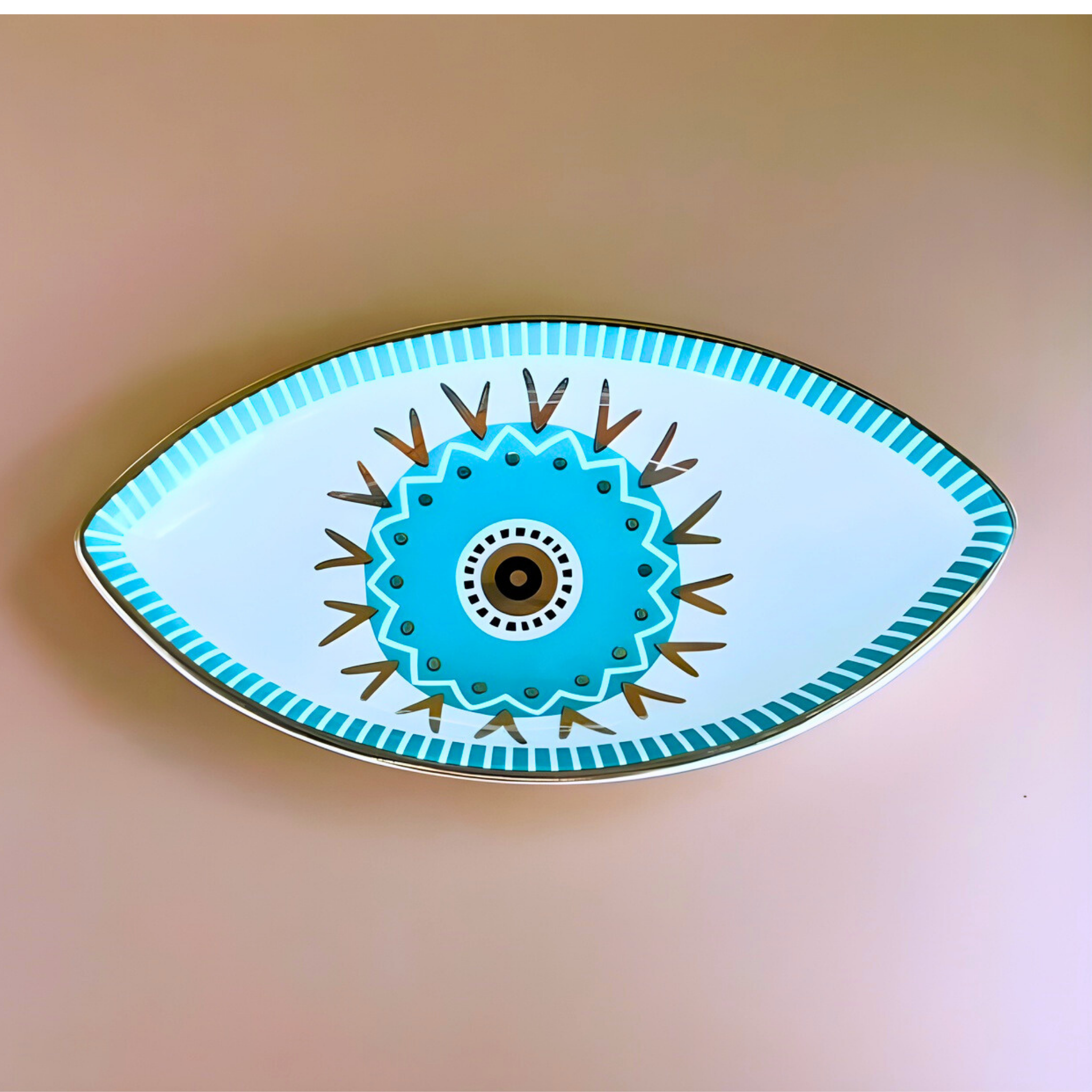 Decorative plate with eye design on a beige background