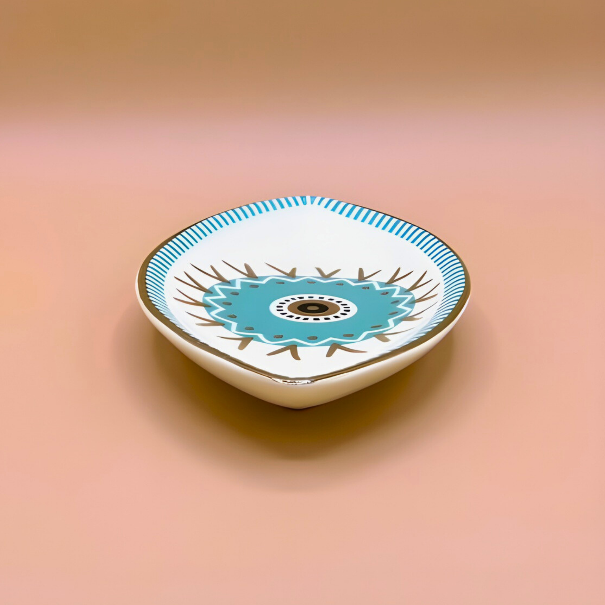 Decorative ceramic bowl with a blue floral design on a peach background