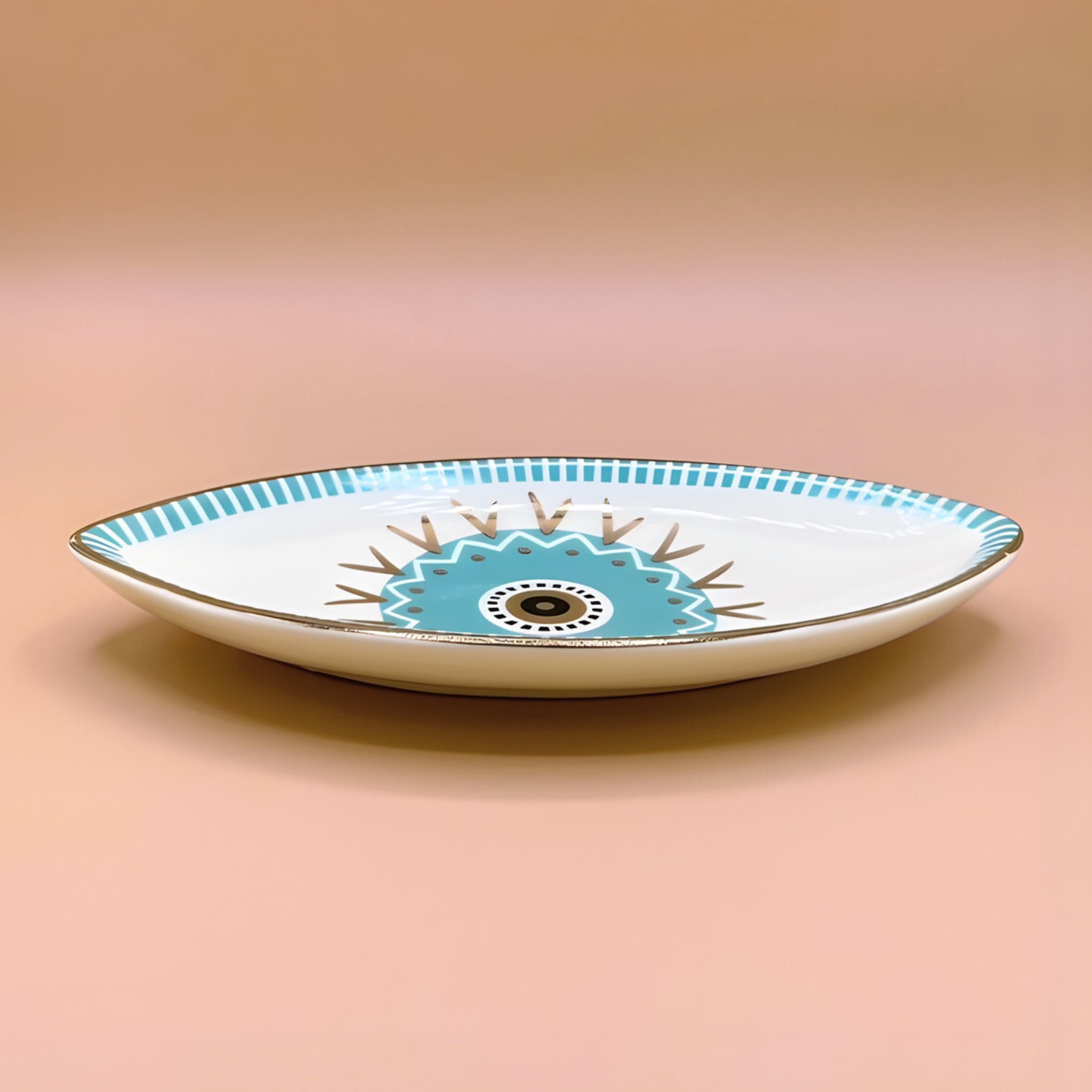 Decorative ceramic plate with blue and white design on a beige background