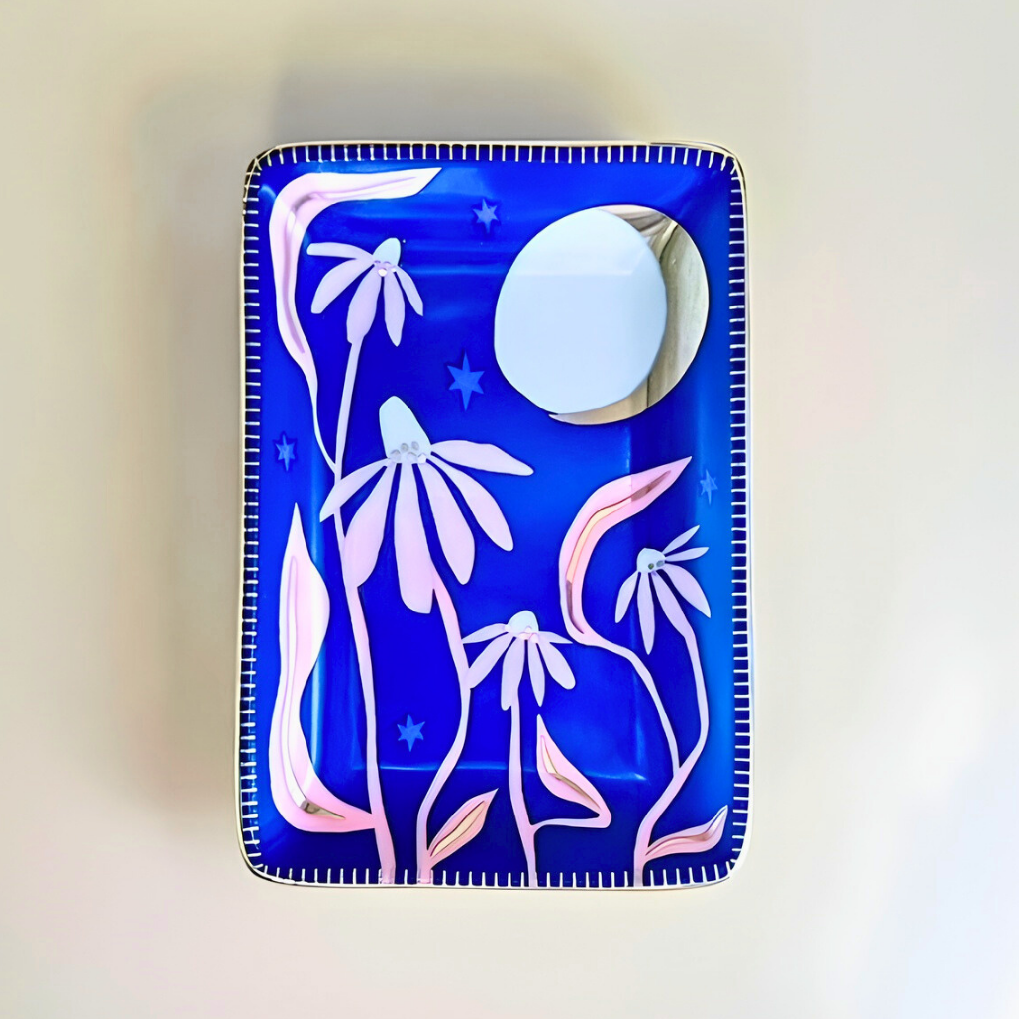 Decorative tray with floral design and moon on a blue background