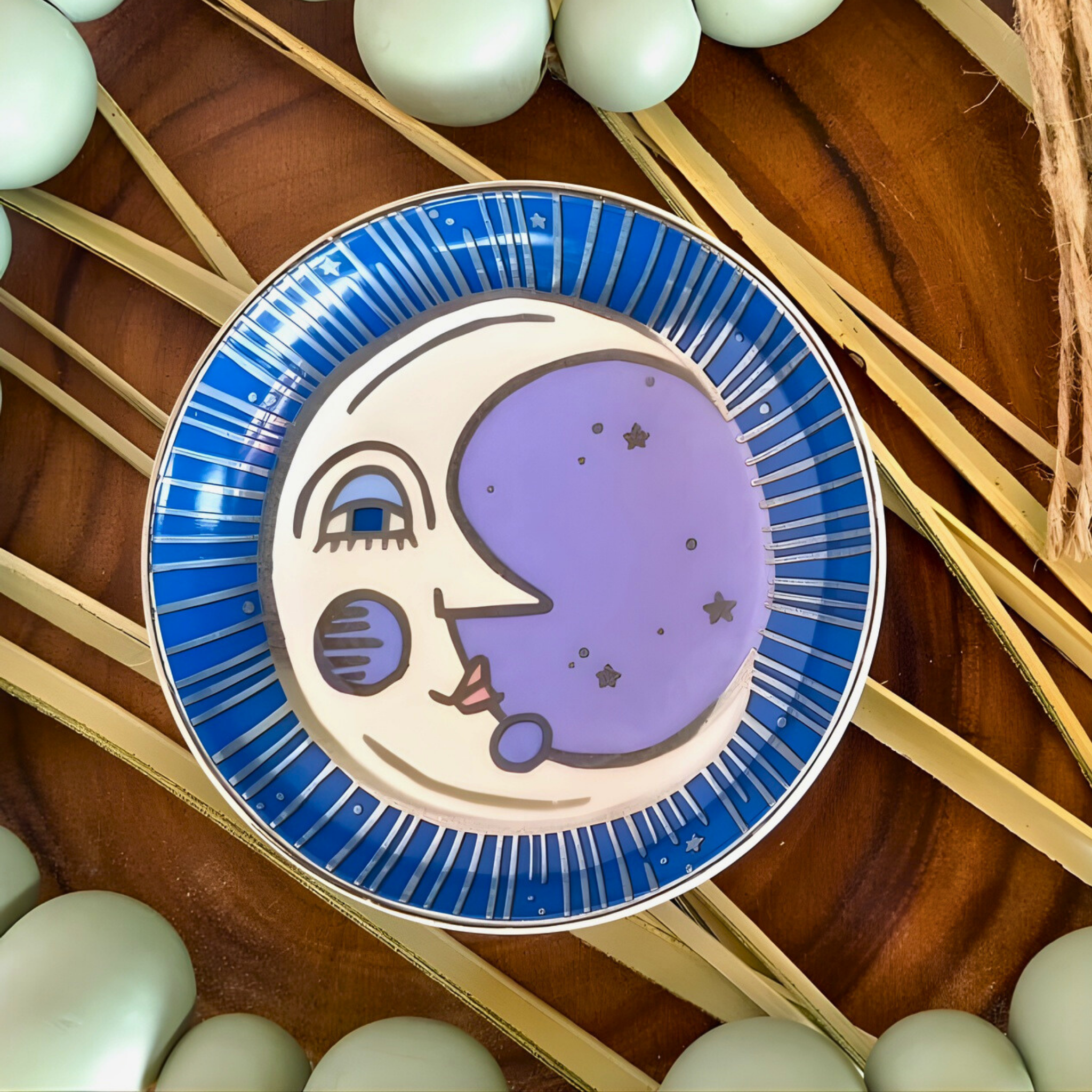 Decorative plate with a moon design on a wooden surface