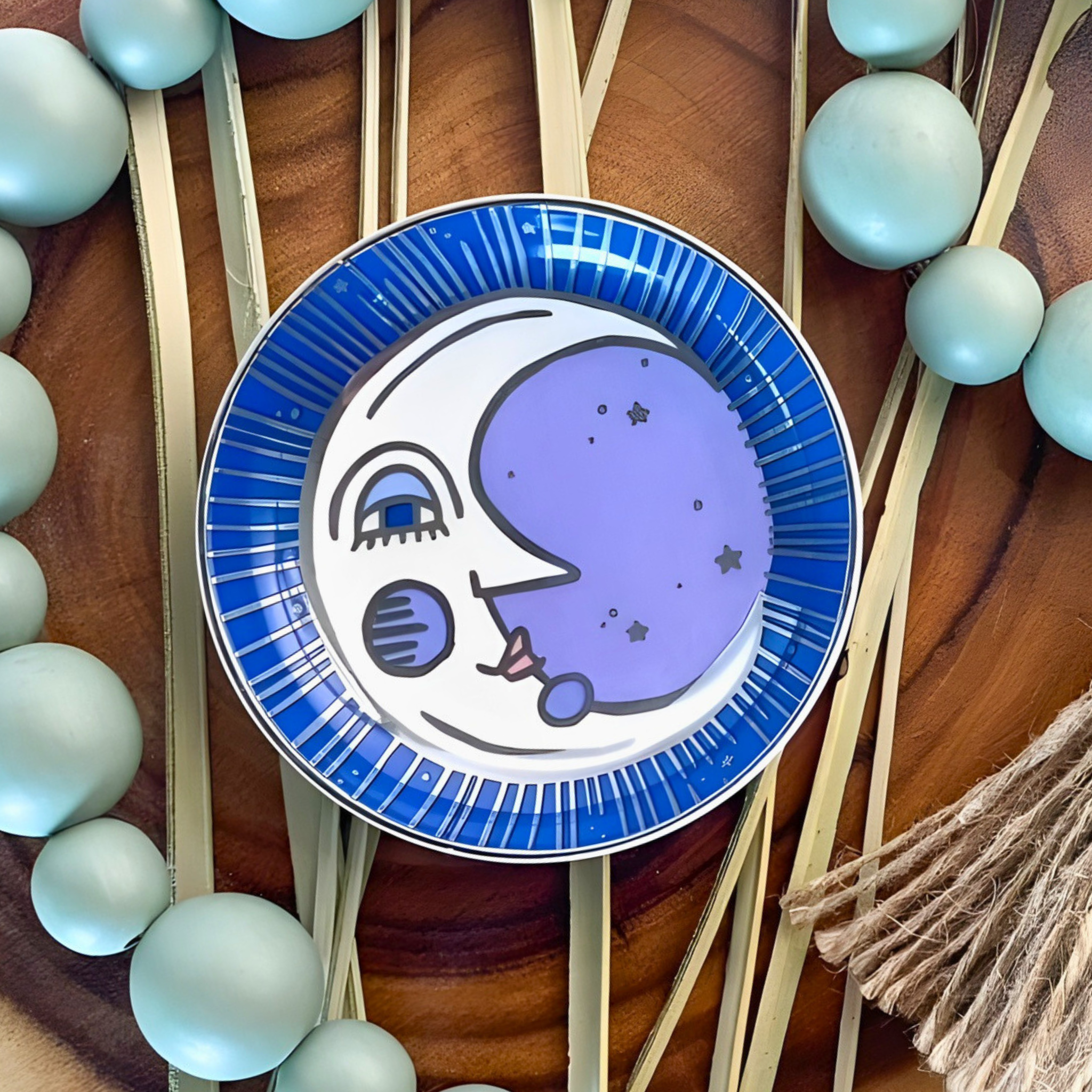 Decorative plate with a moon design on a wooden surface with decorative elements.