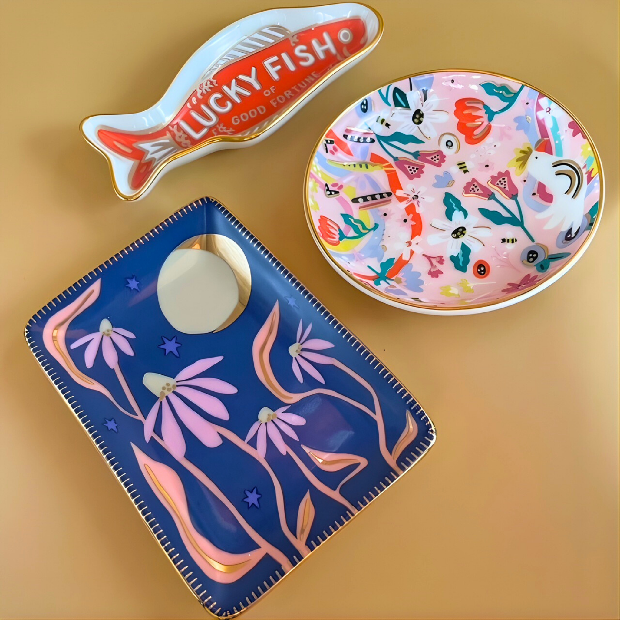 Three decorative plates with different designs on a beige background