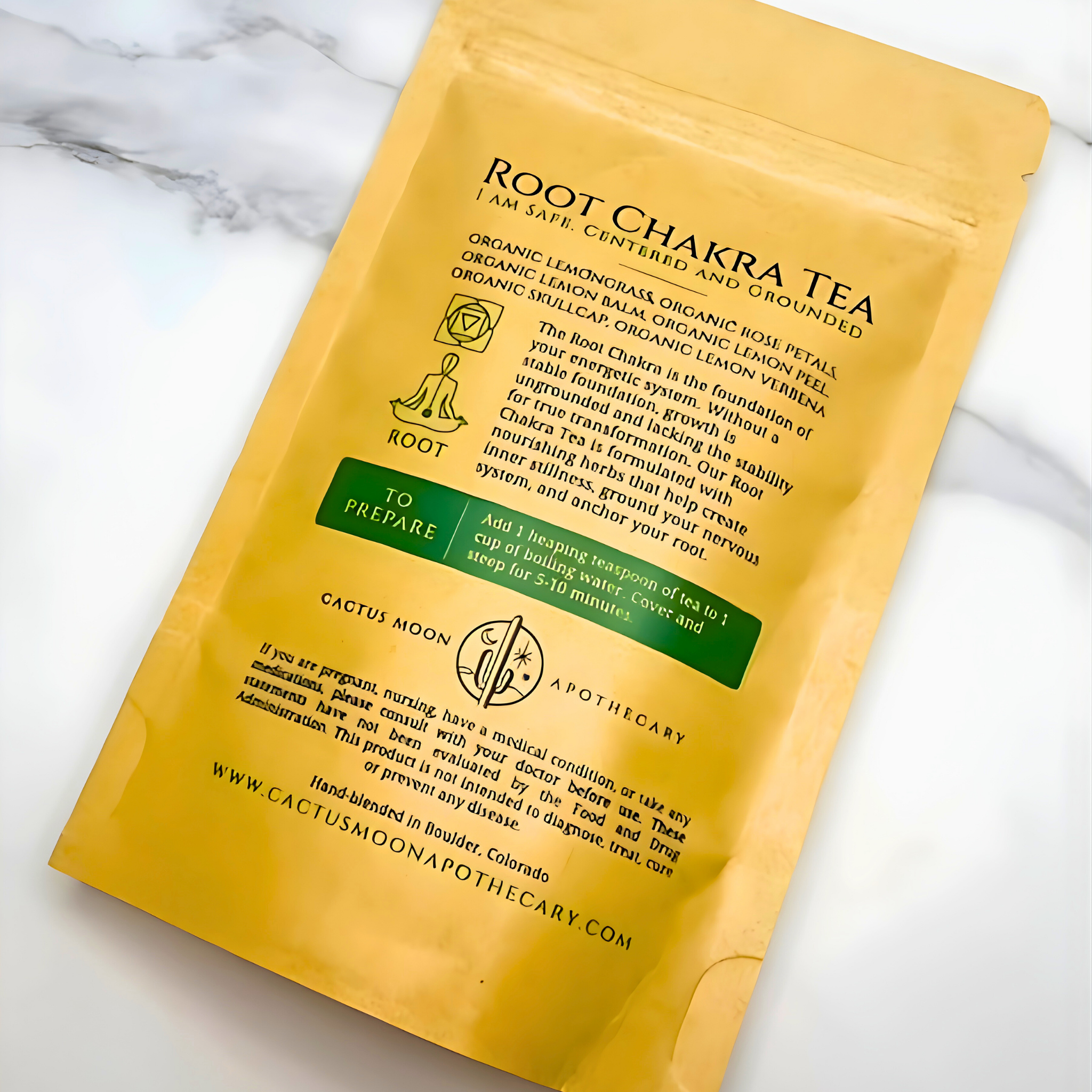 Yellow package of Root Chakra Tea on a marble surface