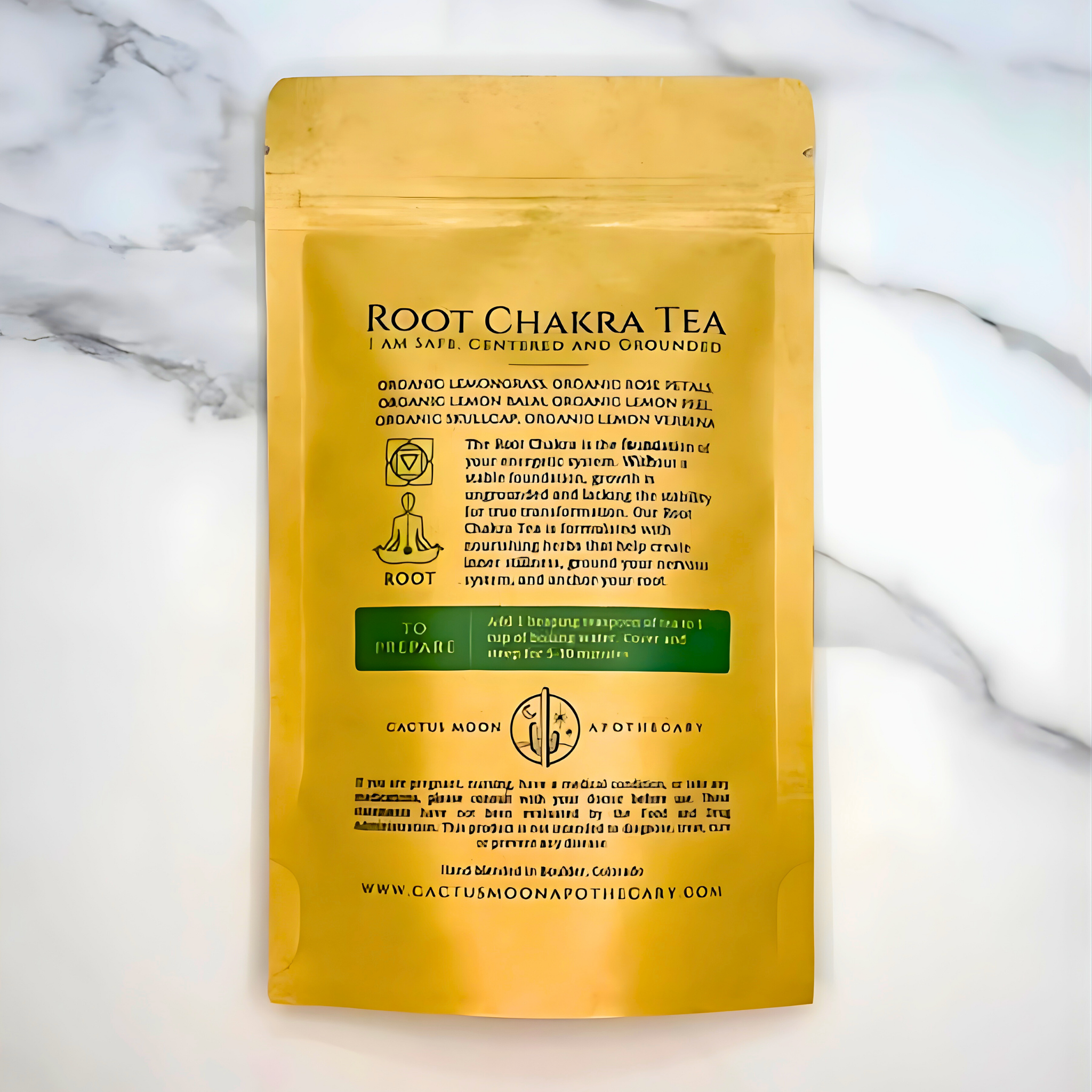 Yellow package of Root Chakra Tea on a marble background