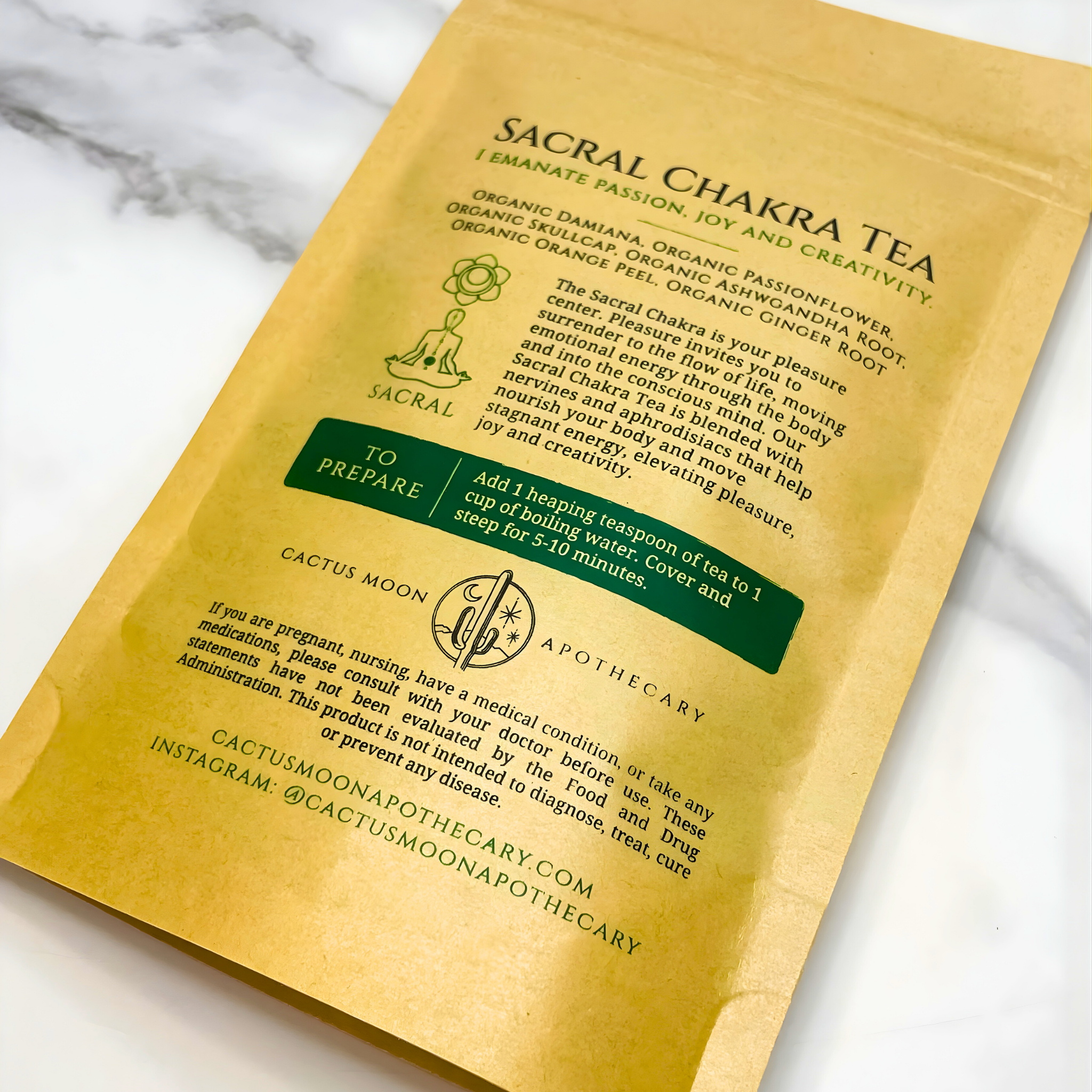 Sacral Chakra Tea package with text and branding on a marble surface