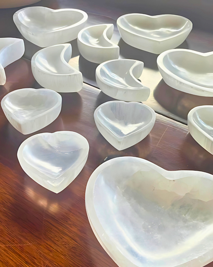 Heart-shaped white ceramic dishes on a wooden surface