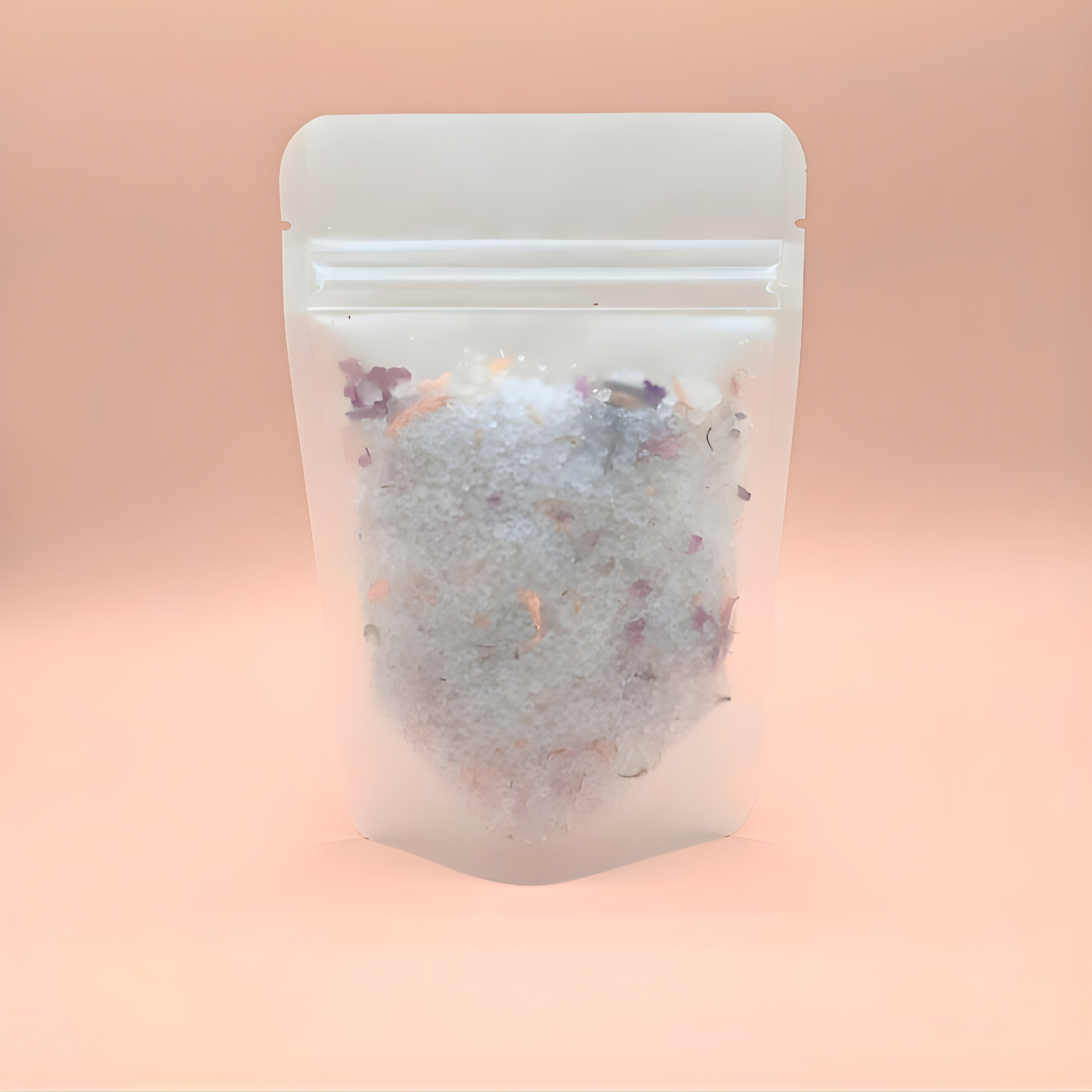 Bath bomb in a clear plastic packaging with a white lid on a pink background