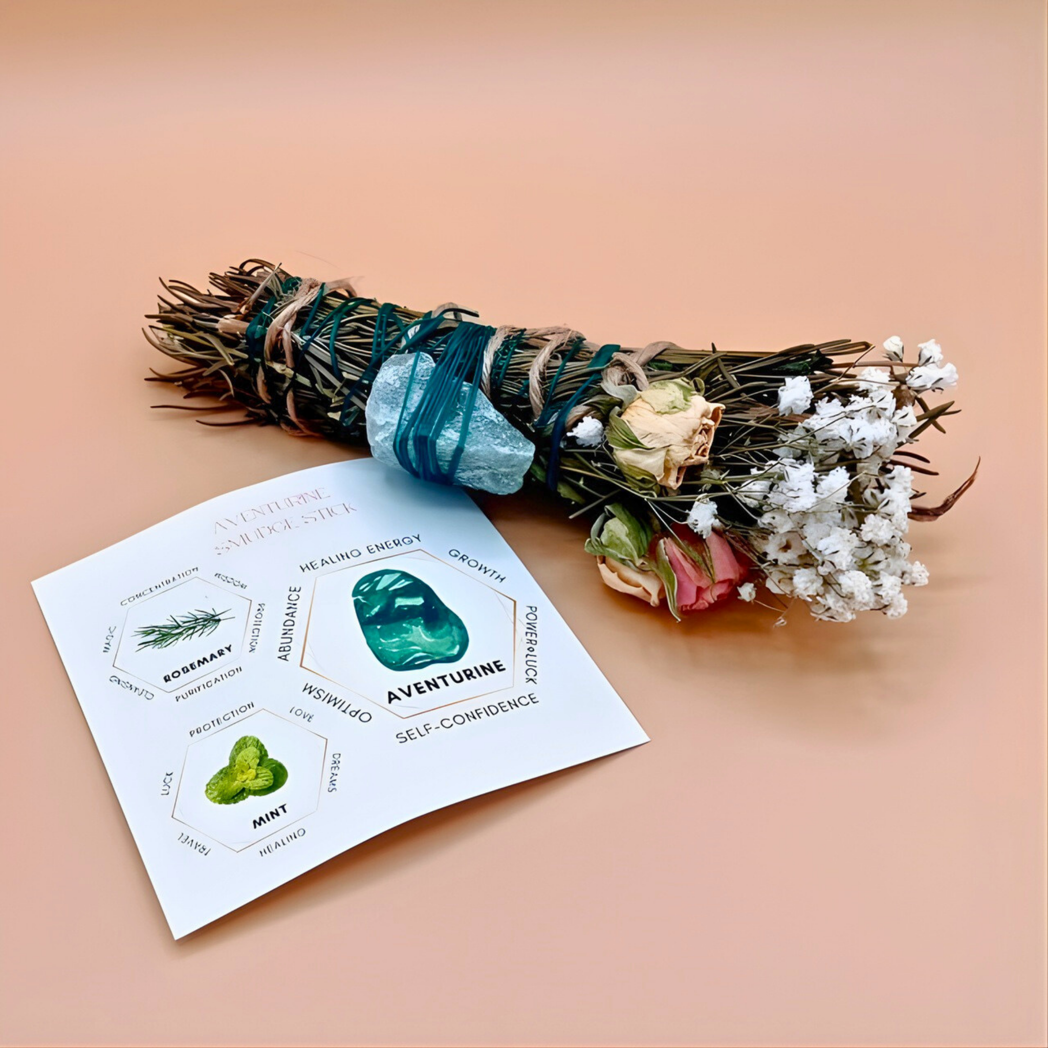 Bouquet of herbs with a green stone and a card on a peach background