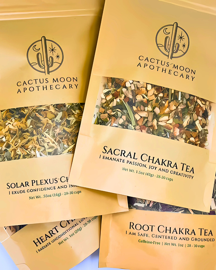 Cactus Moon Apothecary chakra tea packages on a light blue background