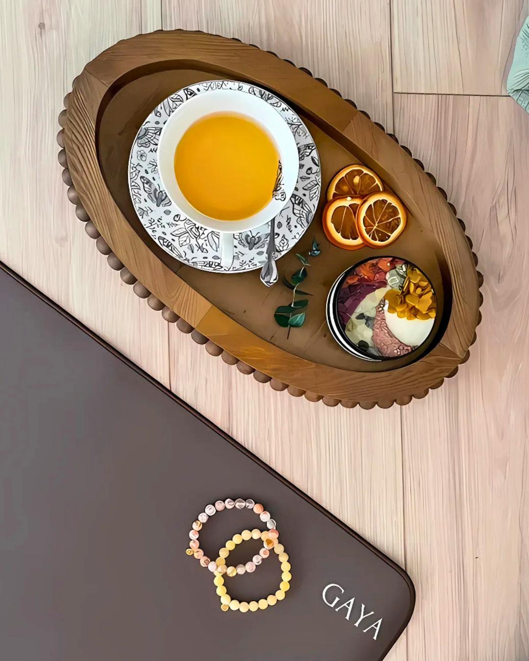 Tea set with a bowl of fruit on a wooden tray, with 'GAYA' branding visible.