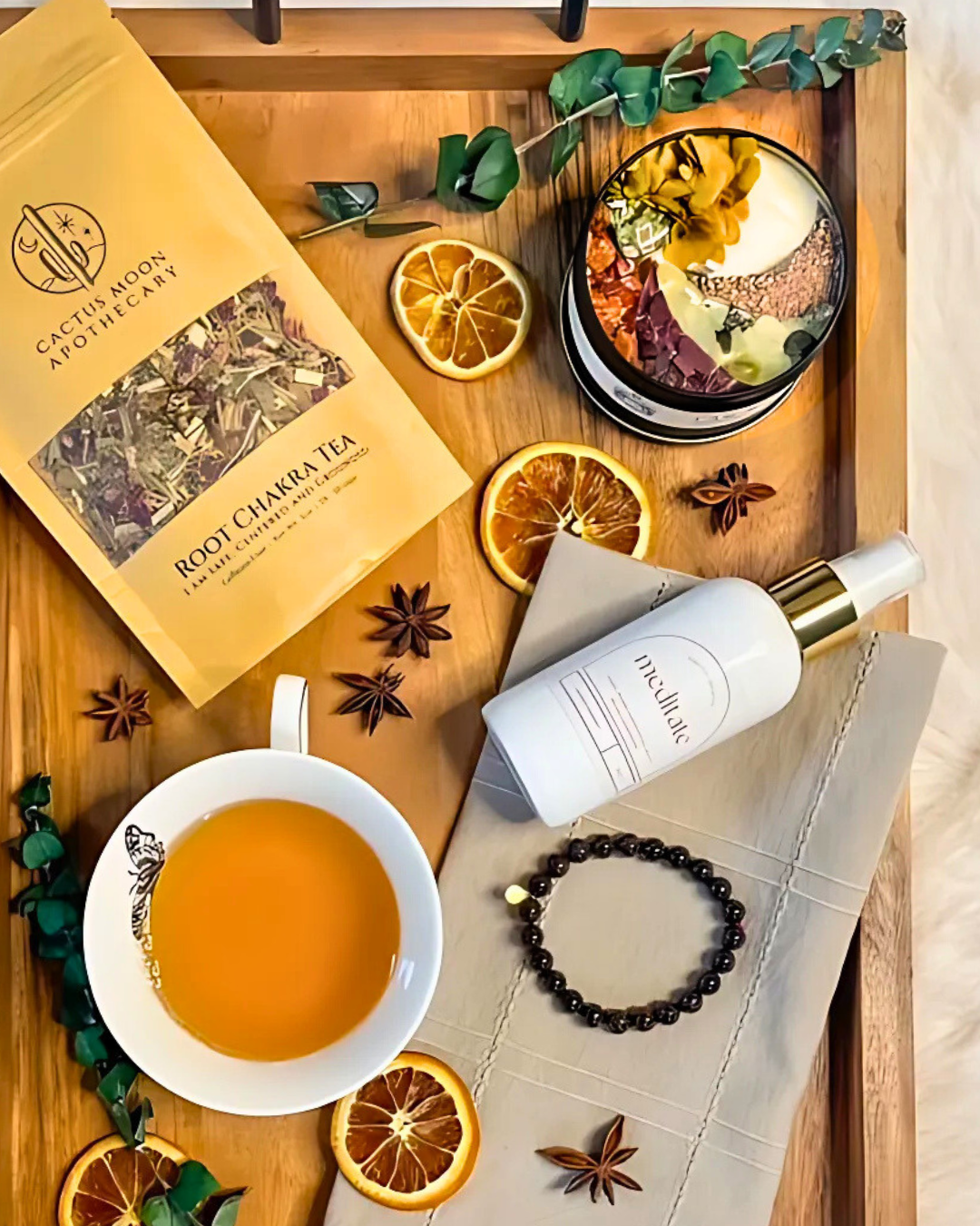 Tea bag, cup of tea, bottle, and decorative elements on a wooden tray
