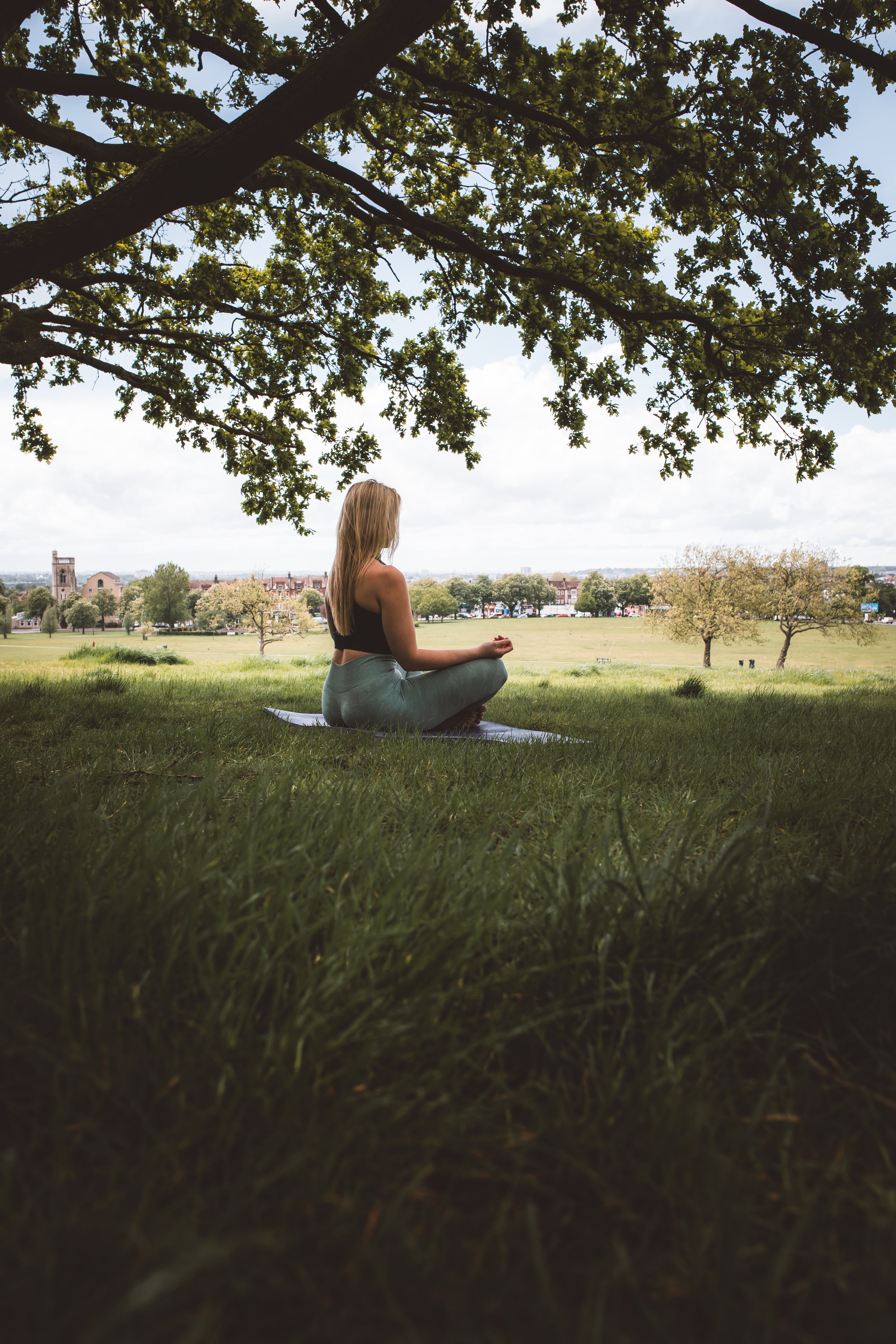 woman meditating under tree meditation
